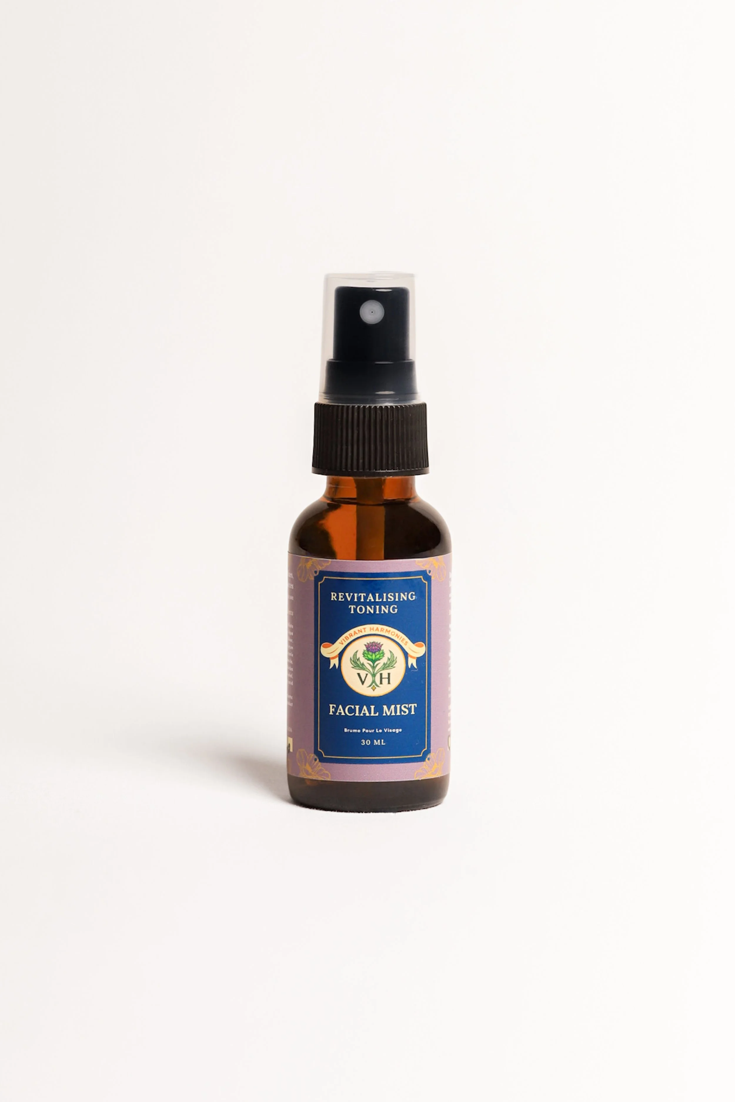 A small amber glass spray bottle labeled 'Revitalising Toning Facial Mist' with a black spray nozzle and a clear cap, against a plain white background.