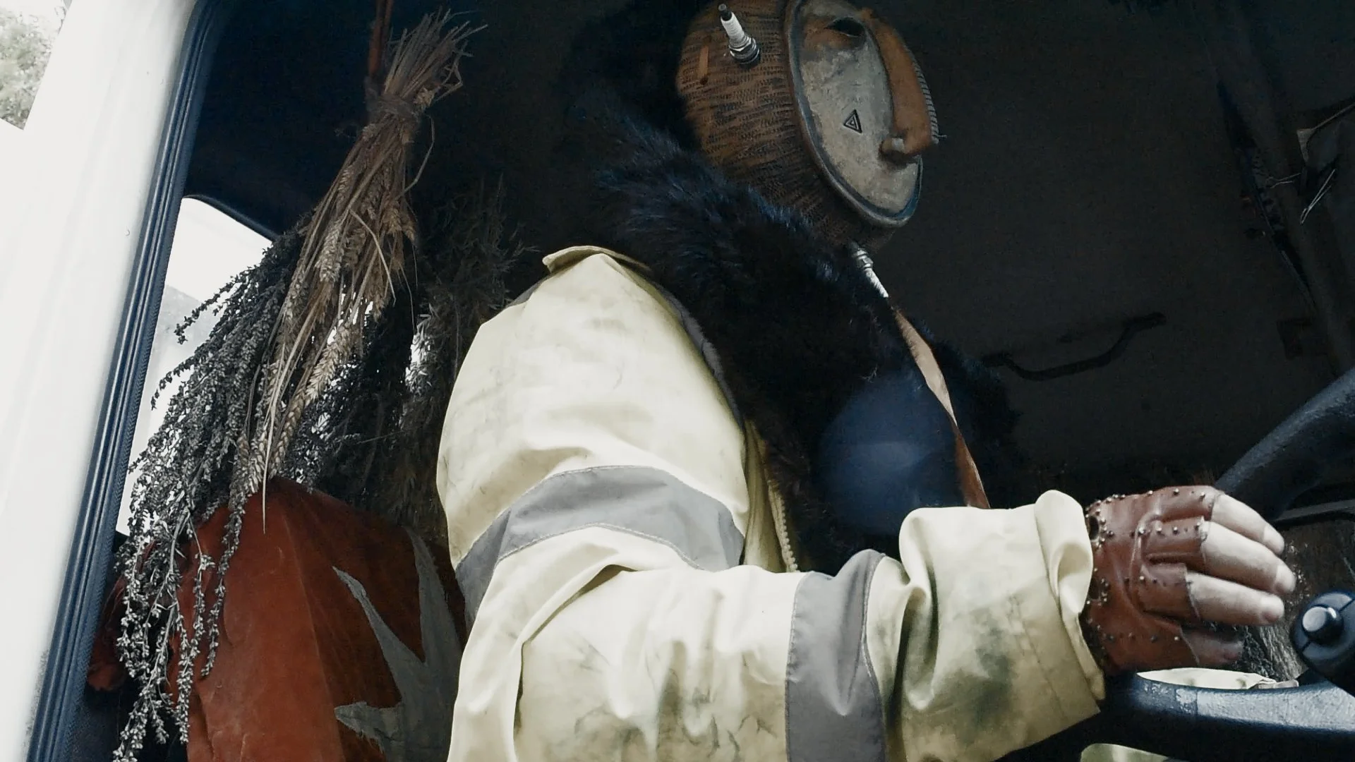 This exhibition will re-tell the folk ritual for the contemporary world - transposing the framework of giving thanks to a process that sustains us, onto the relatable act of road use.

Still from moving image work ROADWYTCH exsisting work to be inclu