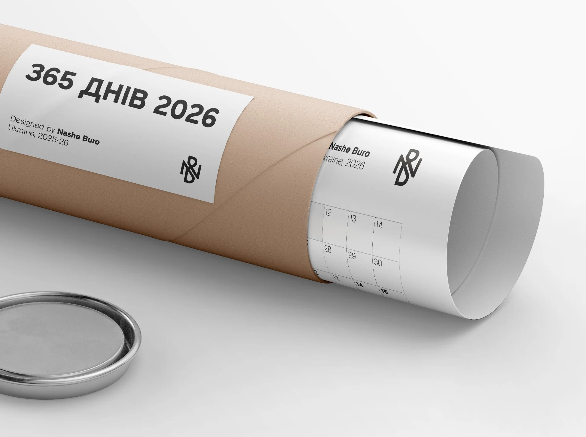 A rolled-up calendar for the year 2026 with a beige sleeve, featuring a black logo and text, and a small metallic container nearby, all on a white surface.