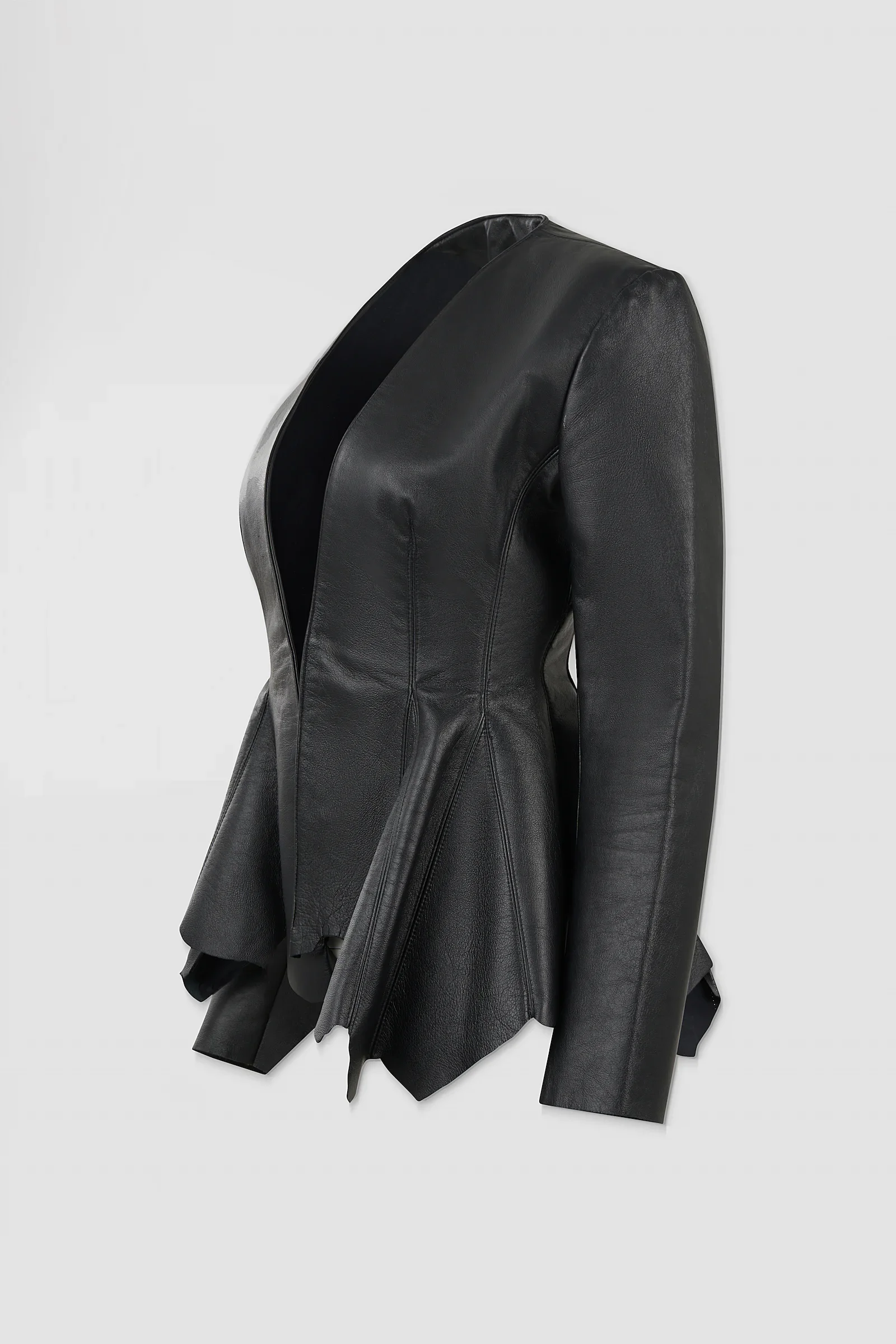 Three-quarter: Side view of the ‘Euryale’ leather jacket showing its fitted tailoring, structured shoulders and flared, irregular leather panels.
