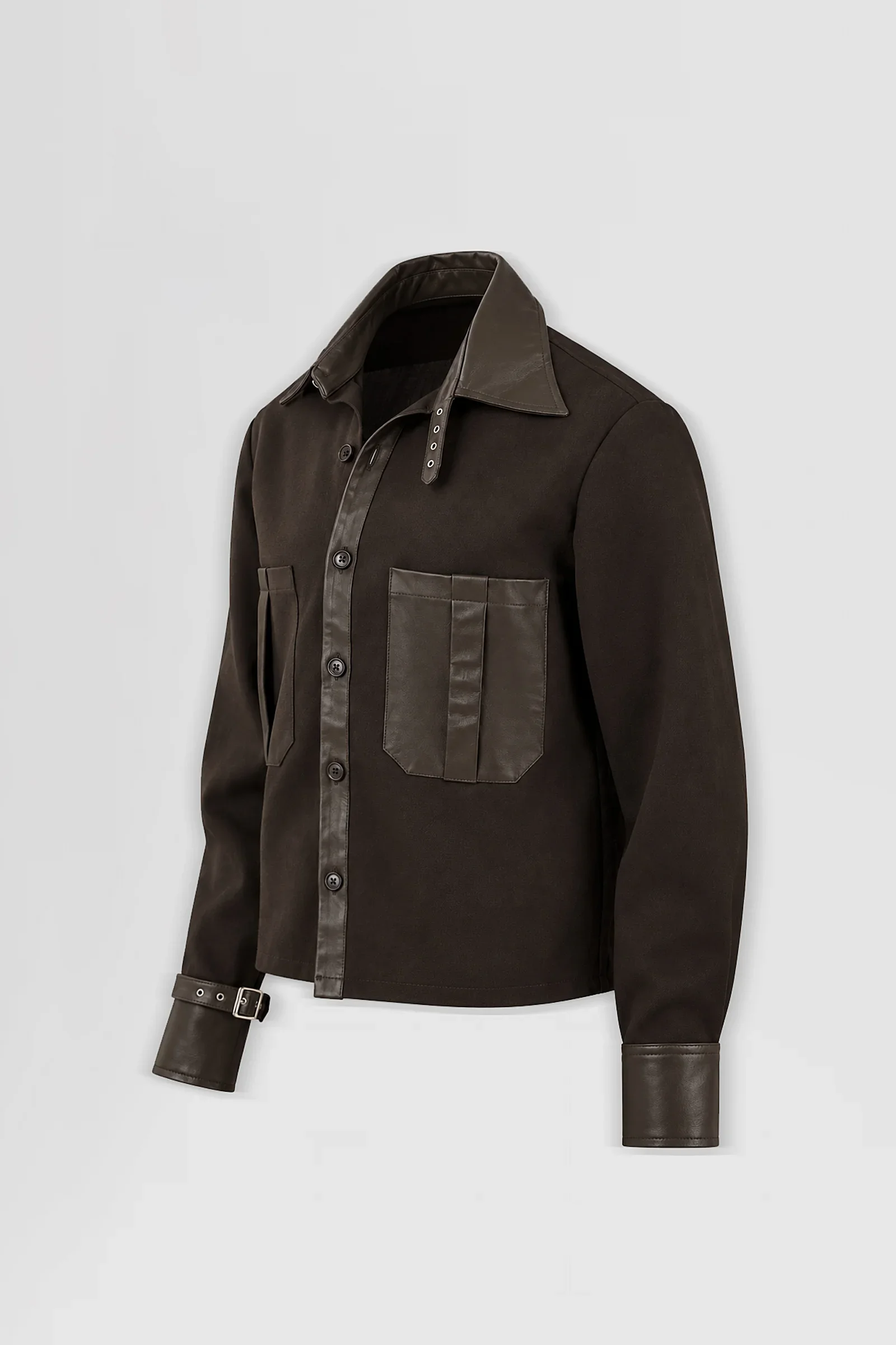 Three-quarter: Three-quarter view of the Stheno brown leather-trimmed overshirt showing its pointed collar, asymmetric patch pockets and buckle cuff detailing.