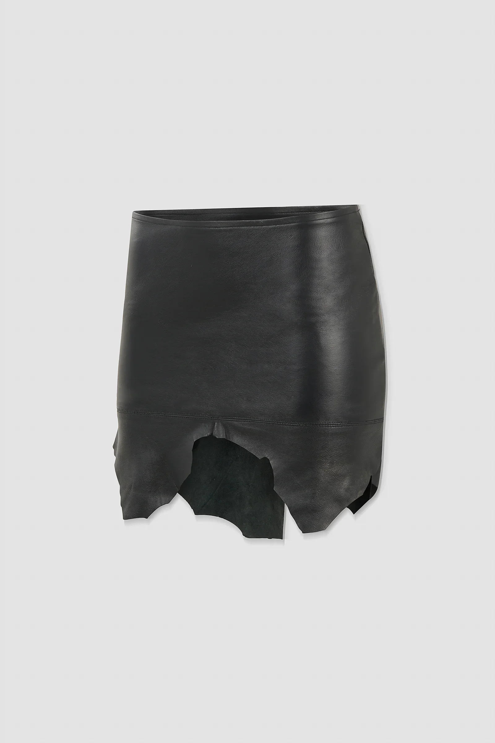 Back: Back view of the ‘Euryale’ black leather micro mini skirt featuring a horizontal panel seam and organic raw-cut hem.