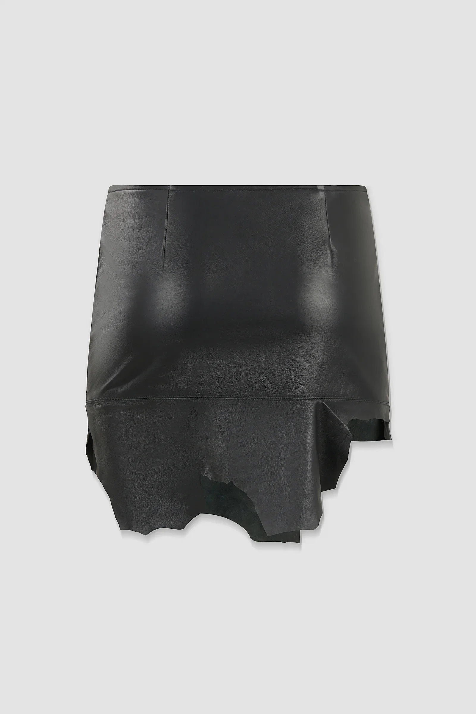 Back: Back view of the ‘Euryale’ black leather micro mini skirt featuring a horizontal panel seam and organic raw-cut hem.
