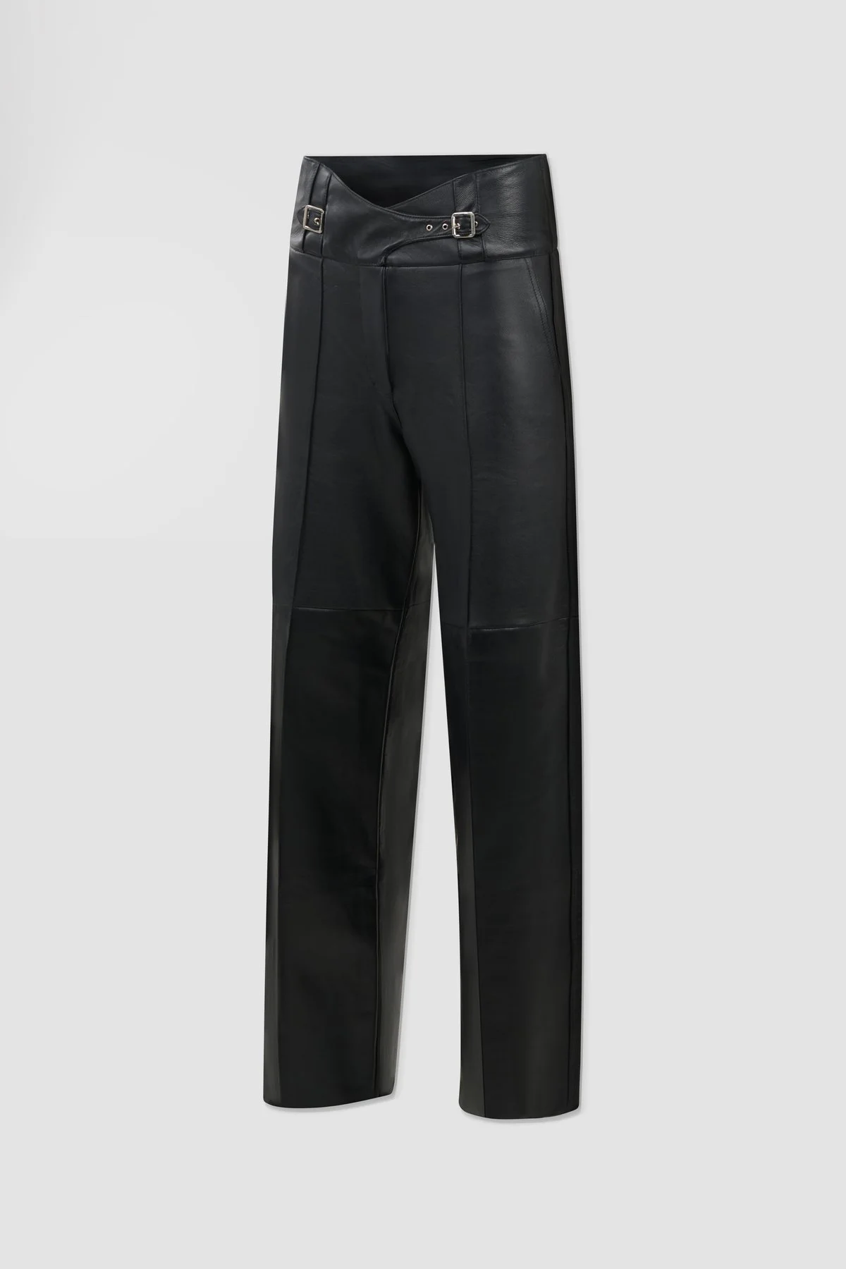 Three-quarter view of black leather trousers showing crossover waist construction, front seams and straight-leg silhouette