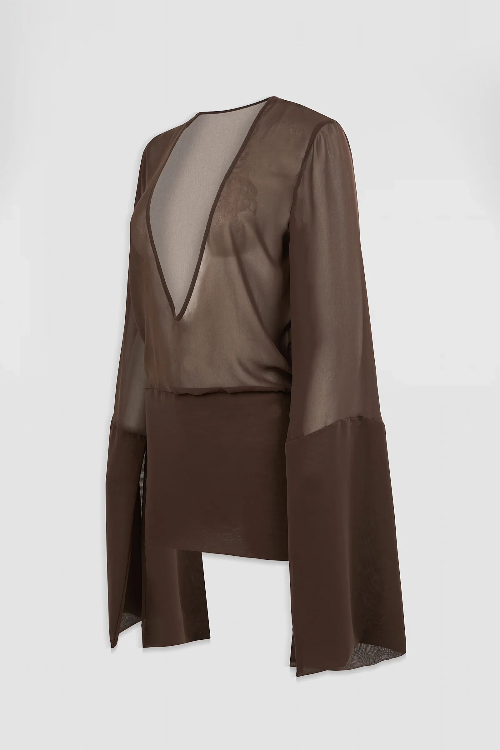 Side: Three-quarter view of the Medusa sheer chiffon mini dress showing its relaxed bodice, dramatic neckline and extended sleeve cuffs.