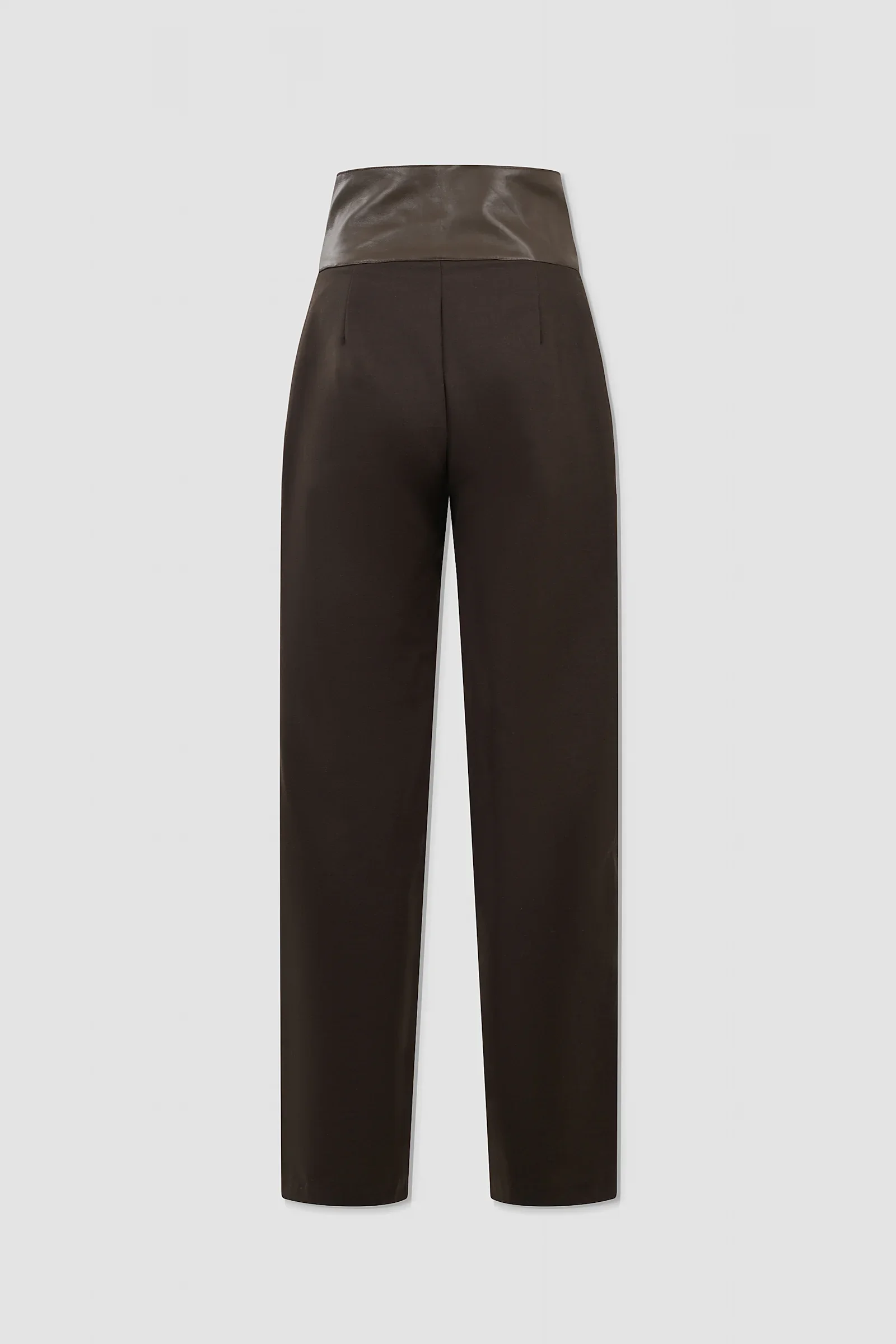 Three-quarter: Three-quarter view of ARAKHNE chocolate brown wool and leather trousers showing the crossover waistband, buckle detailing and straight-leg tailoring.