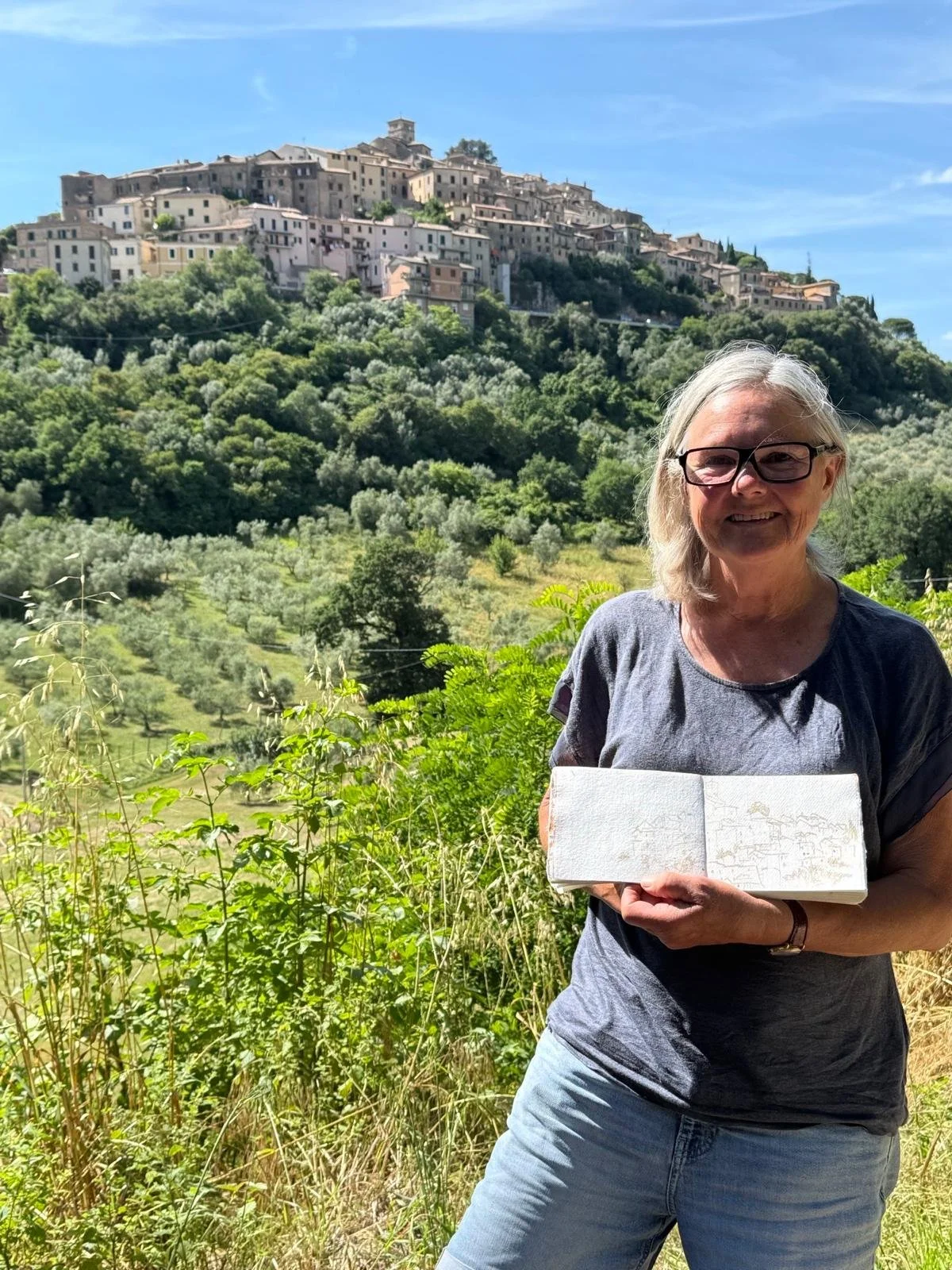 Charlotte with her sketches at her  Charlotte Andrew Art Retreat in the Sabine Hills, Italy.