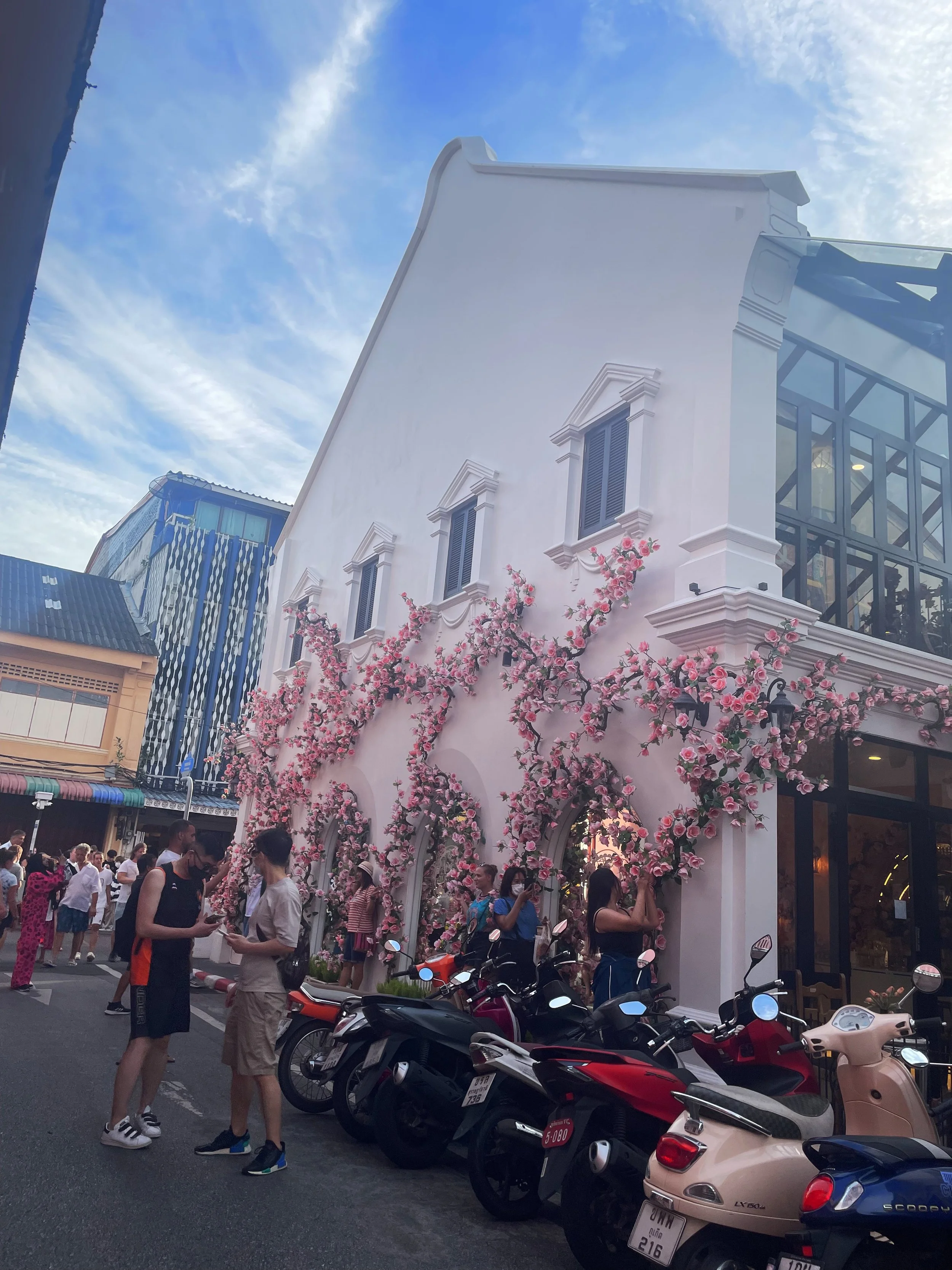 so many people taking pictures along the flower wall.jpeg