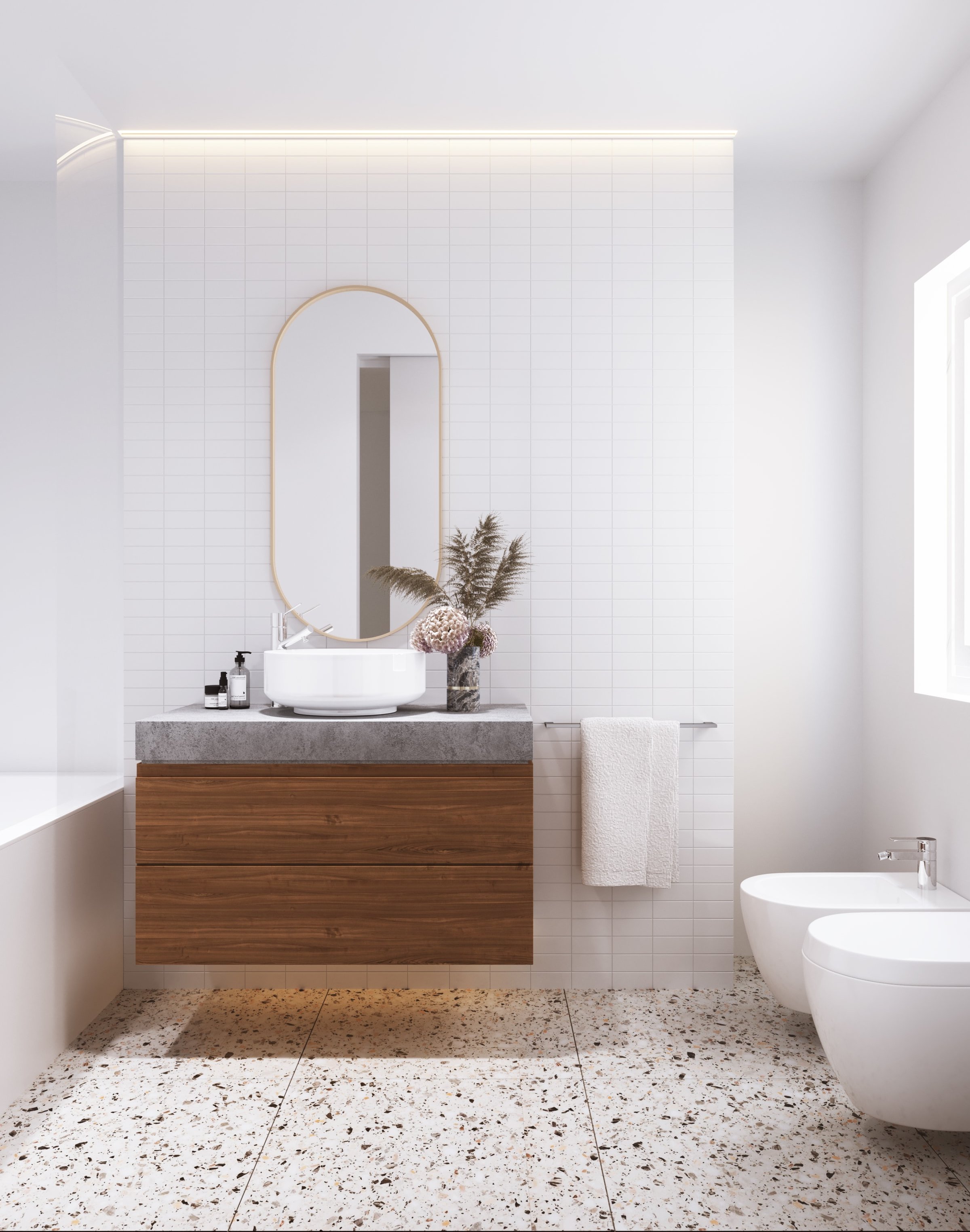 Modern bathroom with wooden vanity, vessel sink, oval mirror, bidet, and terrazzo floor tiles.