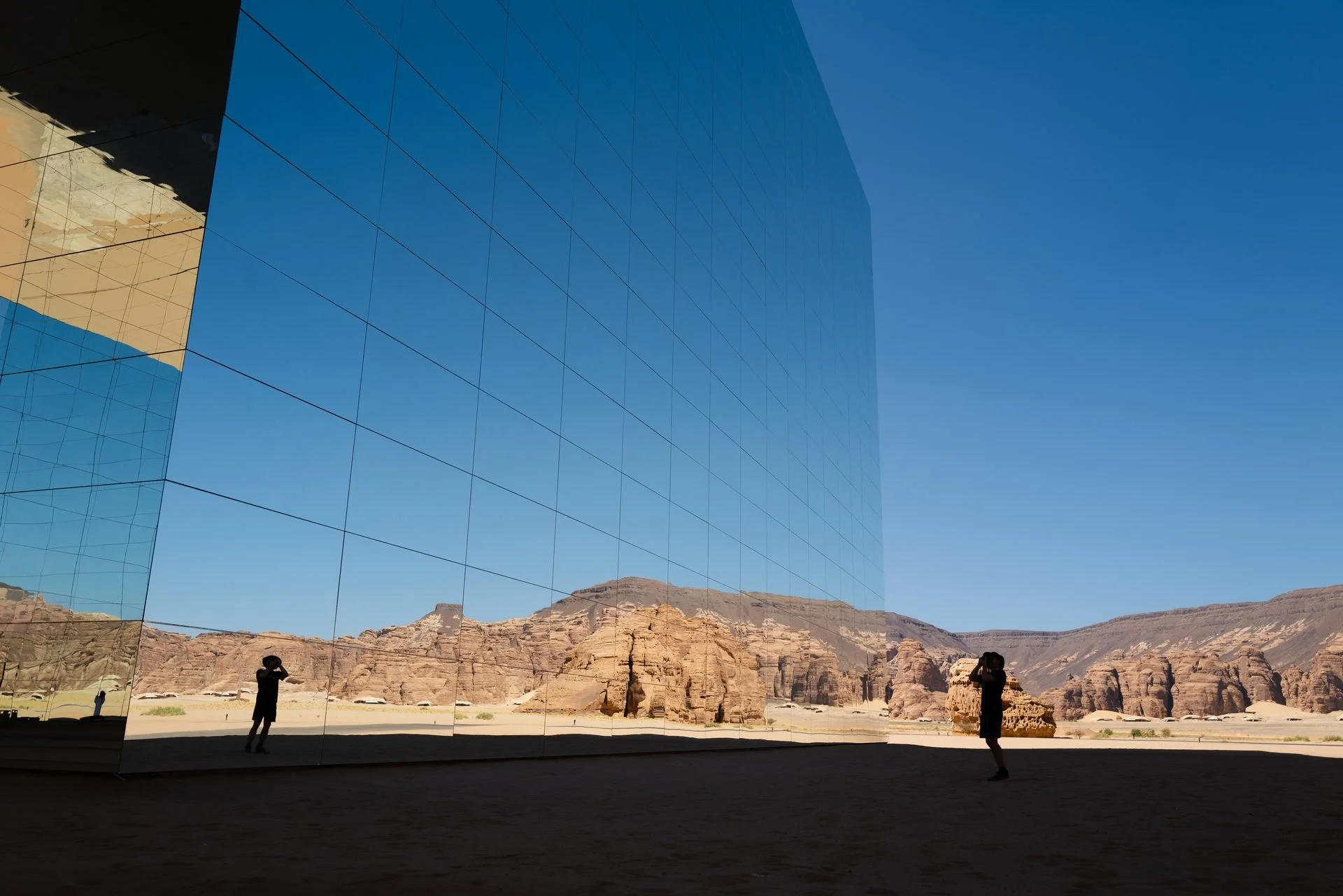 Photographer capturing desert landscape at AlUla sandstone terrain during Evolving Cities Maraya, AlUla