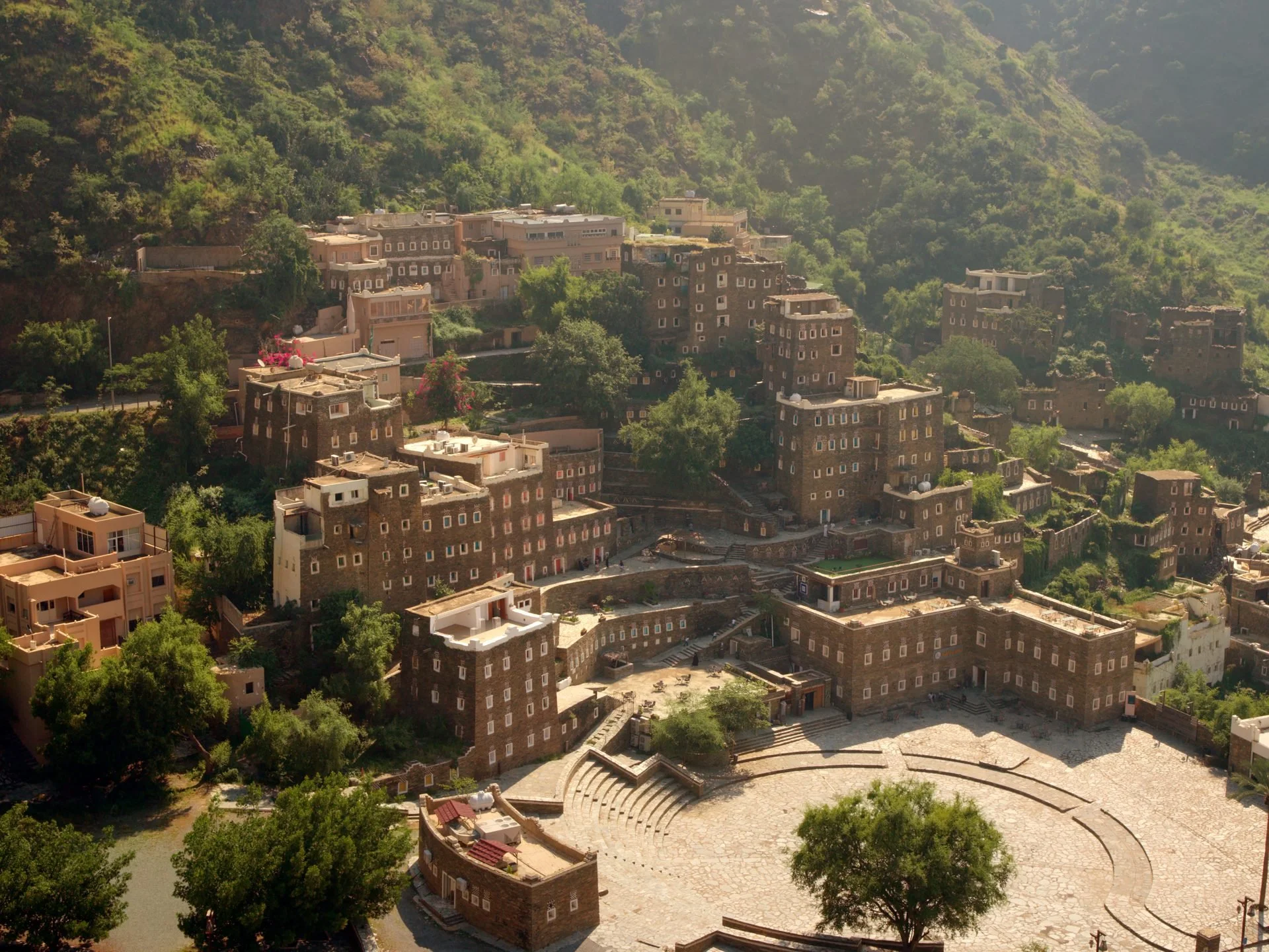 Aerial view of Rijal Almaa - the ancient multi-storey stone tower village built into the
Asir mountain hillside, surrounded by lush green terraces in southwest Saudi Arabia