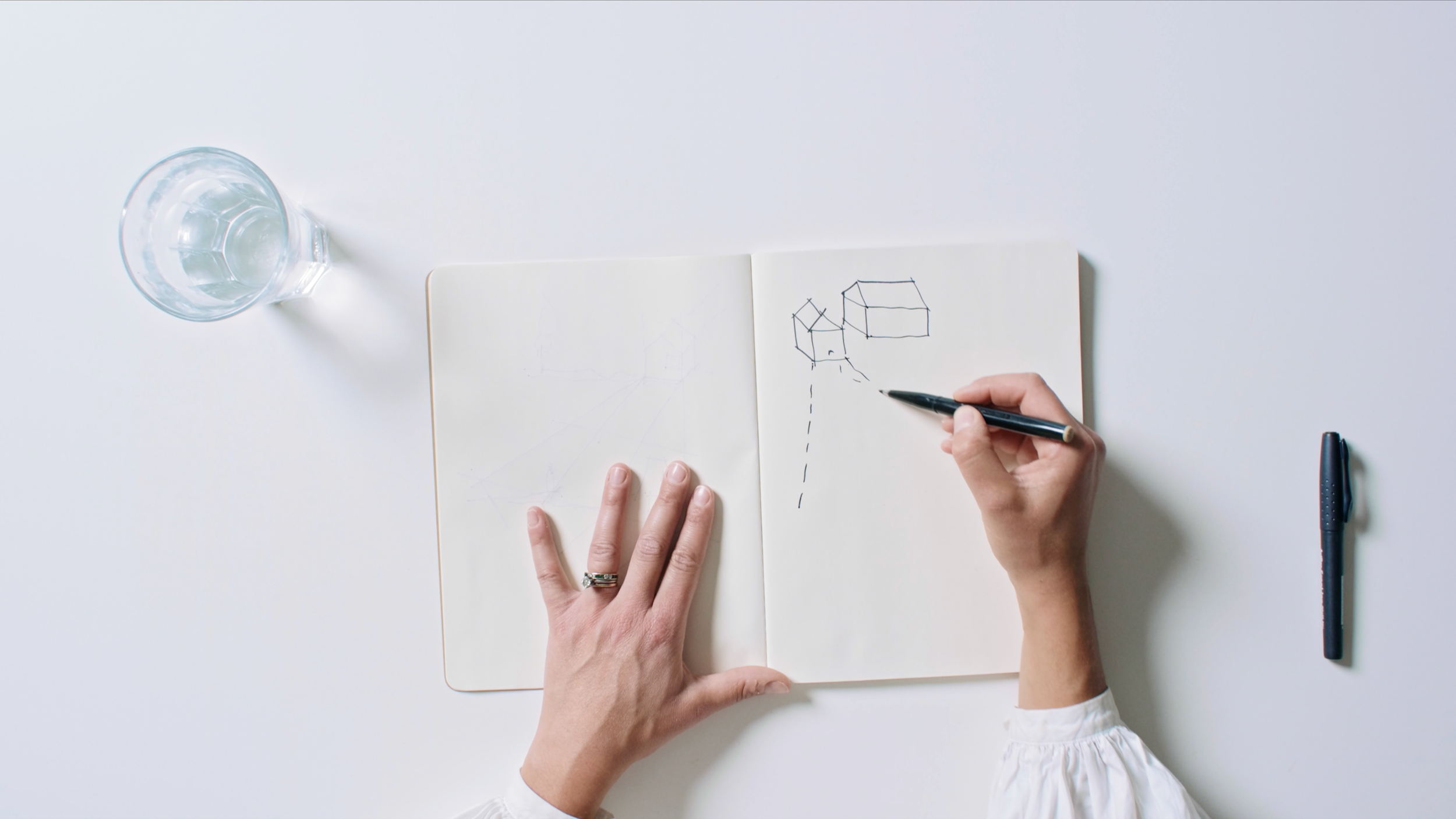 An architect sketching early spatial ideas, showing the design process behind Millharbour from concept to built environment.