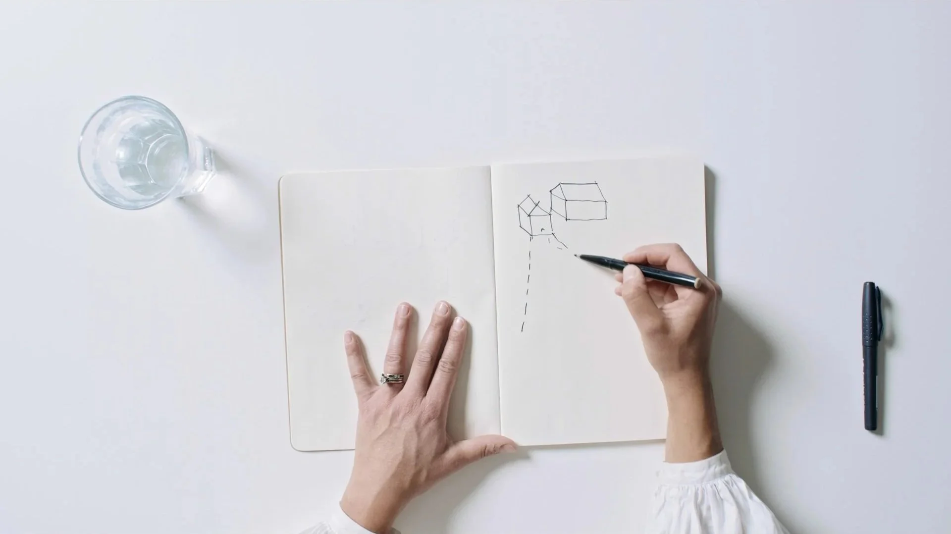 An architect sketching early spatial ideas, showing the design process behind Millharbour from concept to built environment.