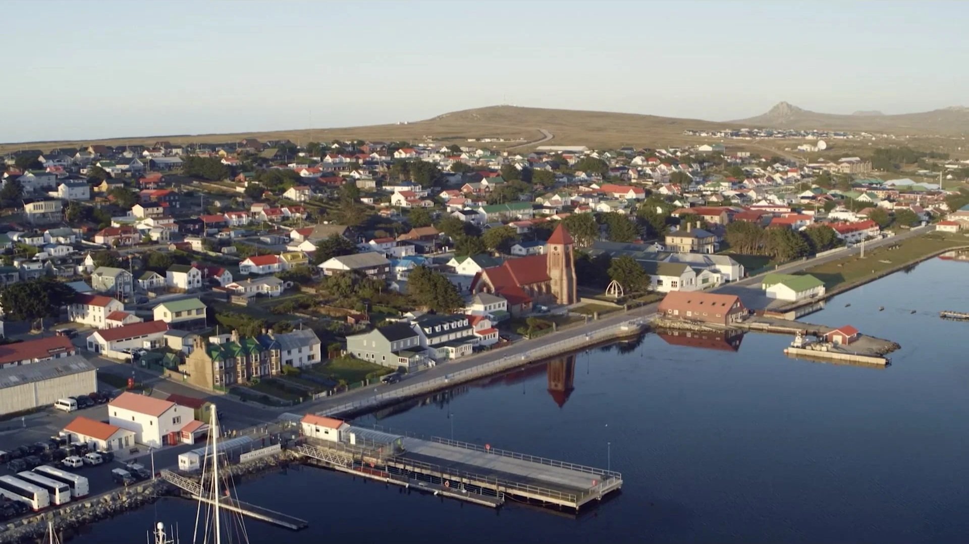 Aerial drone view of Stanley, capital of the Falkland Islands — showing
colourful houses, the red church and harbour, filmed for Connecting the Falklands