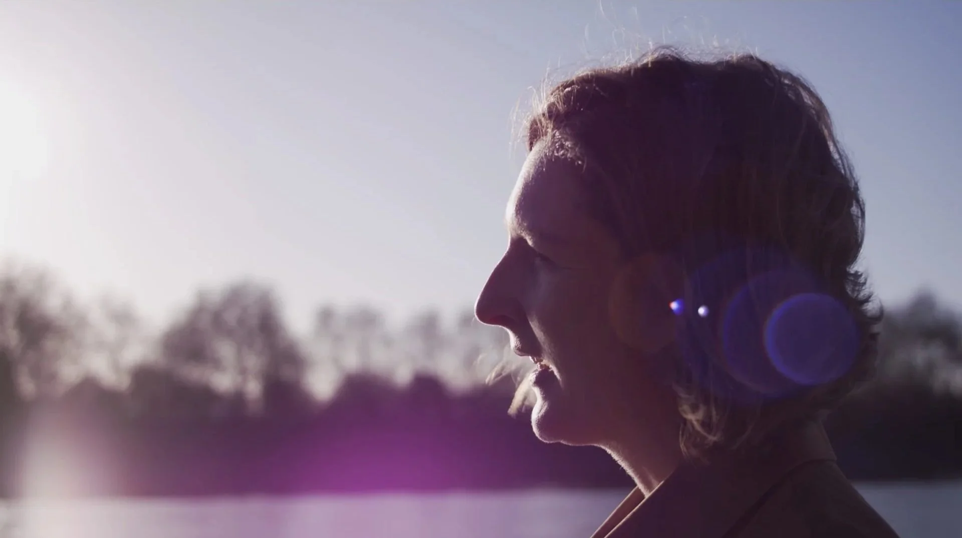Thames Tideway Pocket Parks film — backlit outdoor portrait with lens flare,
interview subject by River Thames, Hawkins/Brown architecture
documentary