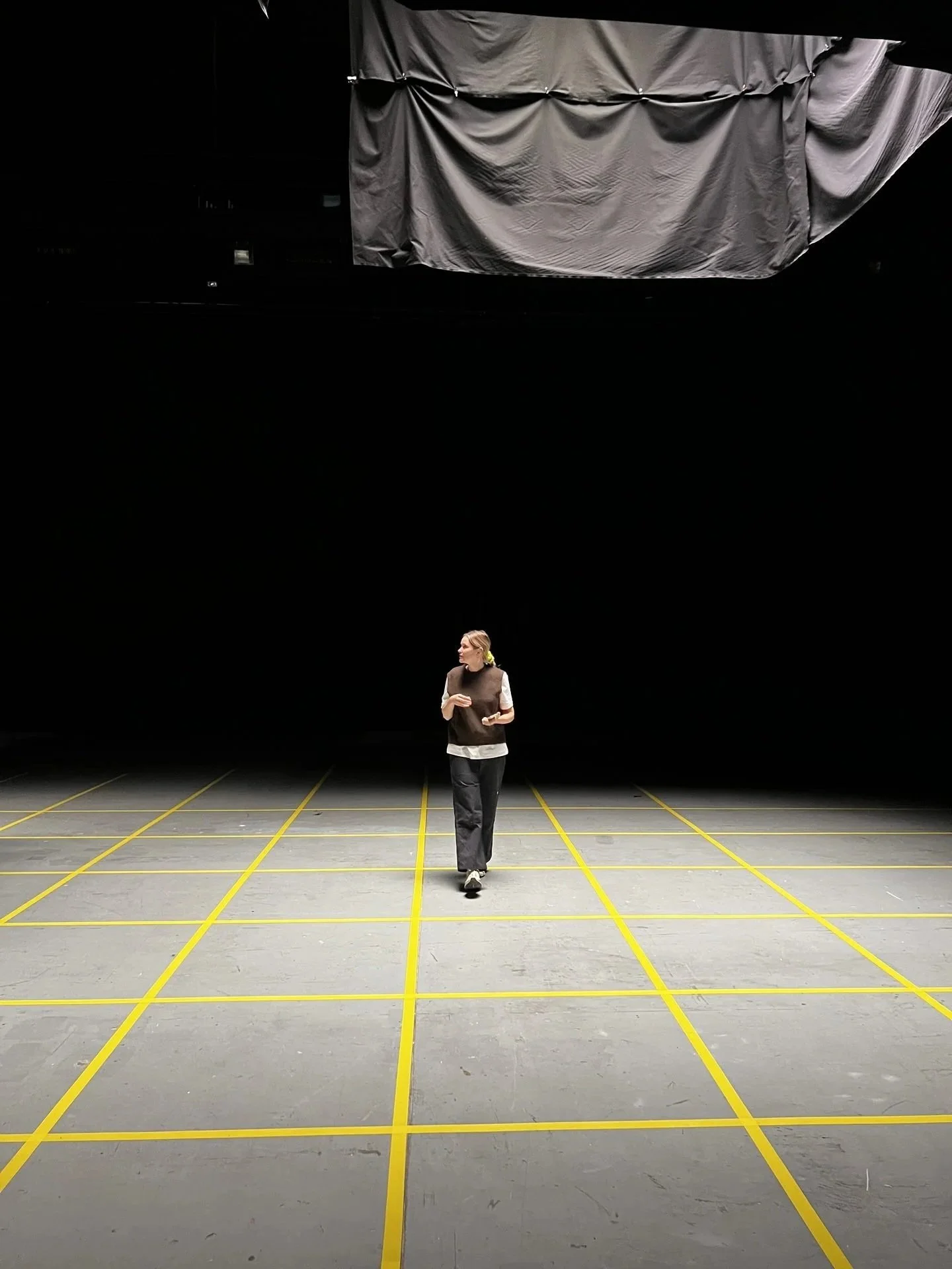 Overhead walkway shot of single performer on lit studio floor with softbox, Marfa Stance,
DOP James Dougan