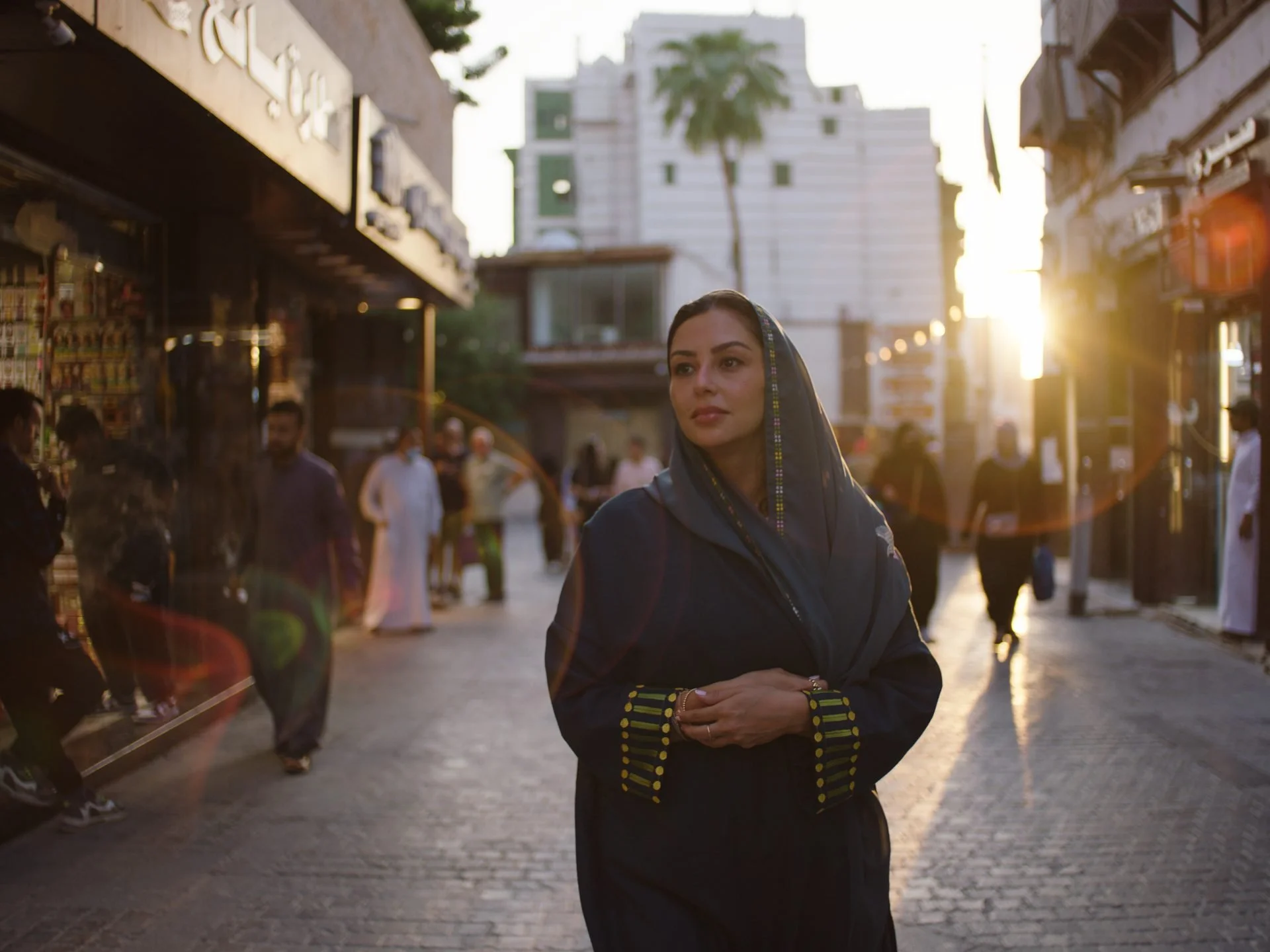A woman in traditional dress walks through a sunlit street in Al Balad, Jeddah - the
UNESCO World Heritage historic district, filmed for Inspired Cities in Evolving Cities