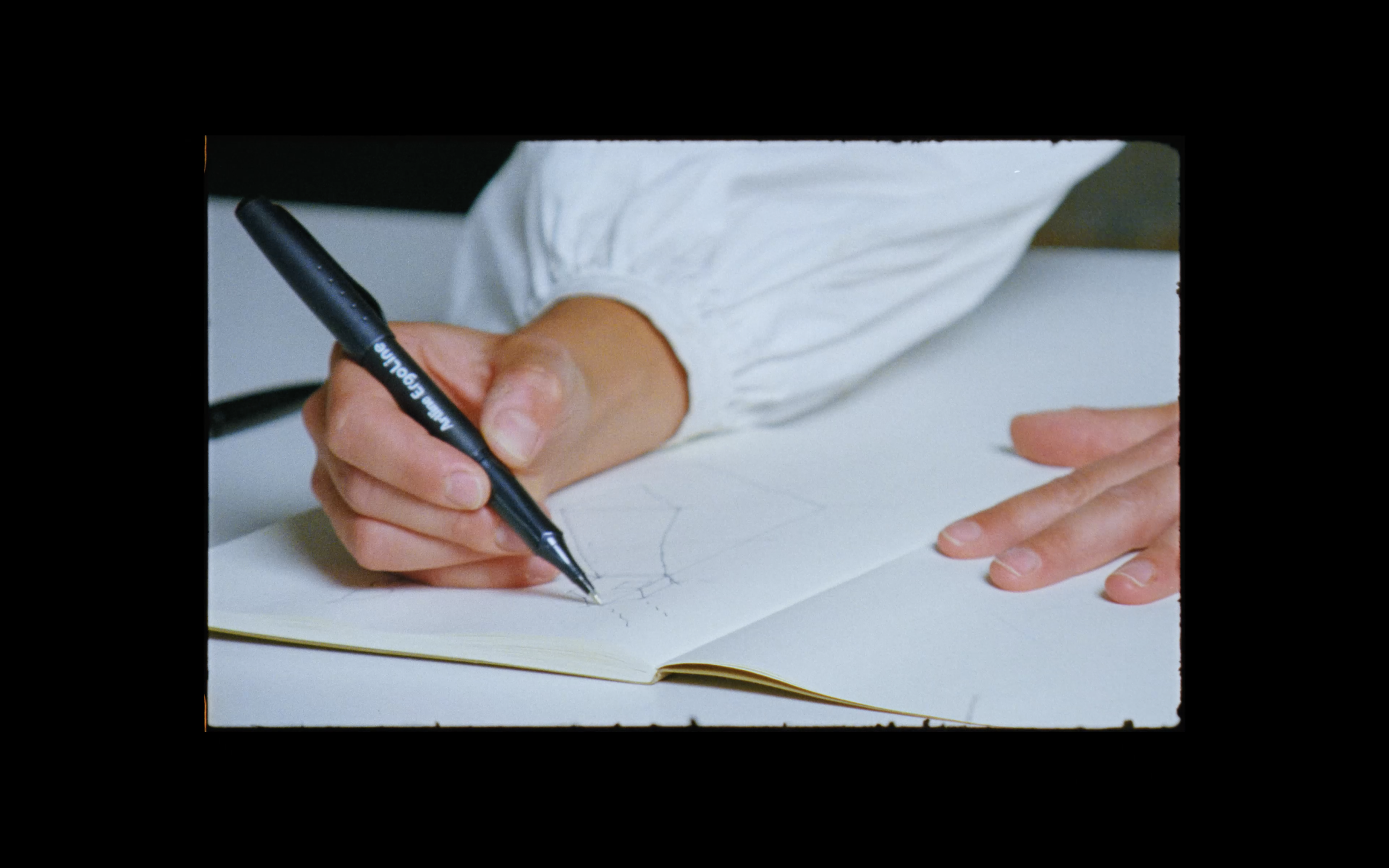 Close-up of architectural drawings captured on 16mm film, emphasising craftsmanship, process, and tactile design thinking.