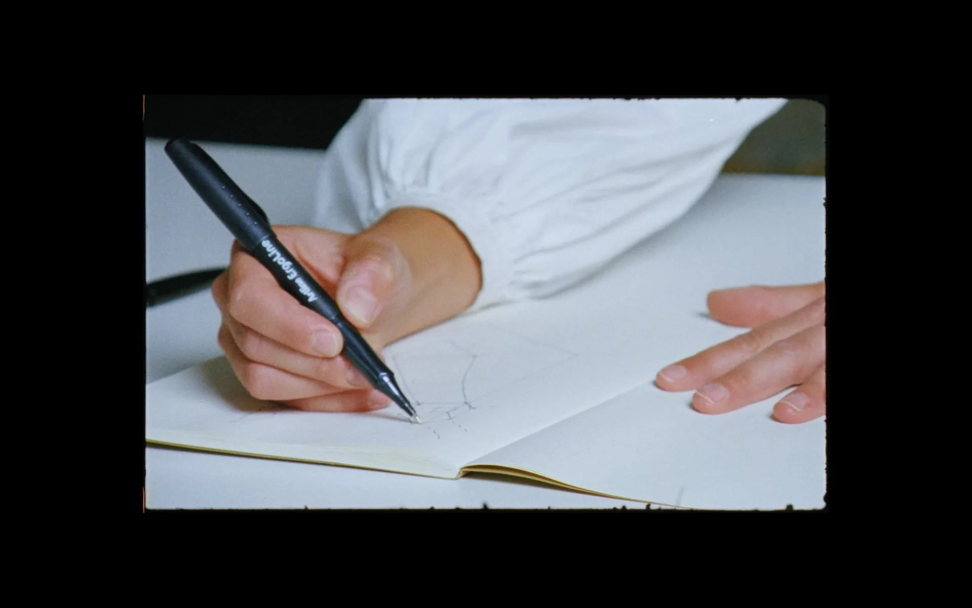 Close-up of architectural drawings captured on 16mm film, emphasising craftsmanship, process, and tactile design thinking.