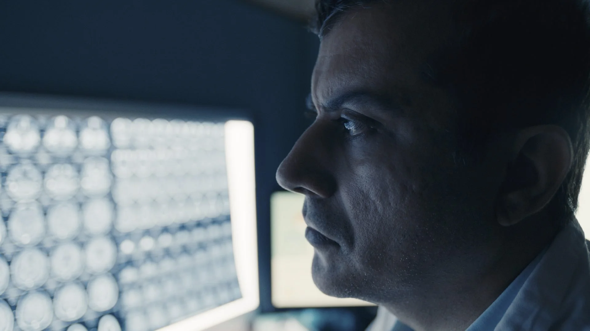 GE Healthcare corporate film — doctor reviewing brain MRI scans on
monitor in dark radiology room, GE digital transformation