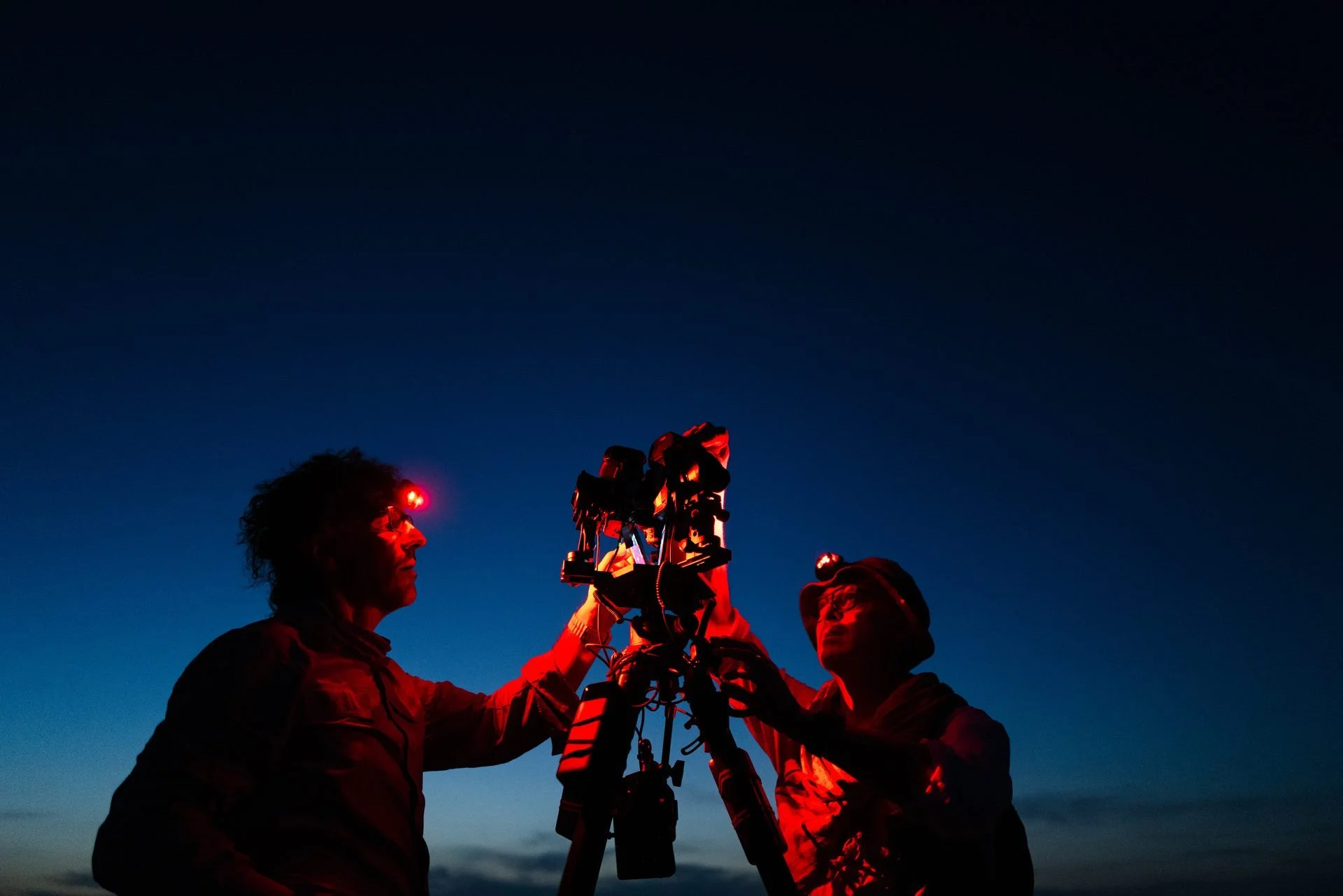 Crew rigging timelapse cameras at blue hour in the desert for Evolving Cities