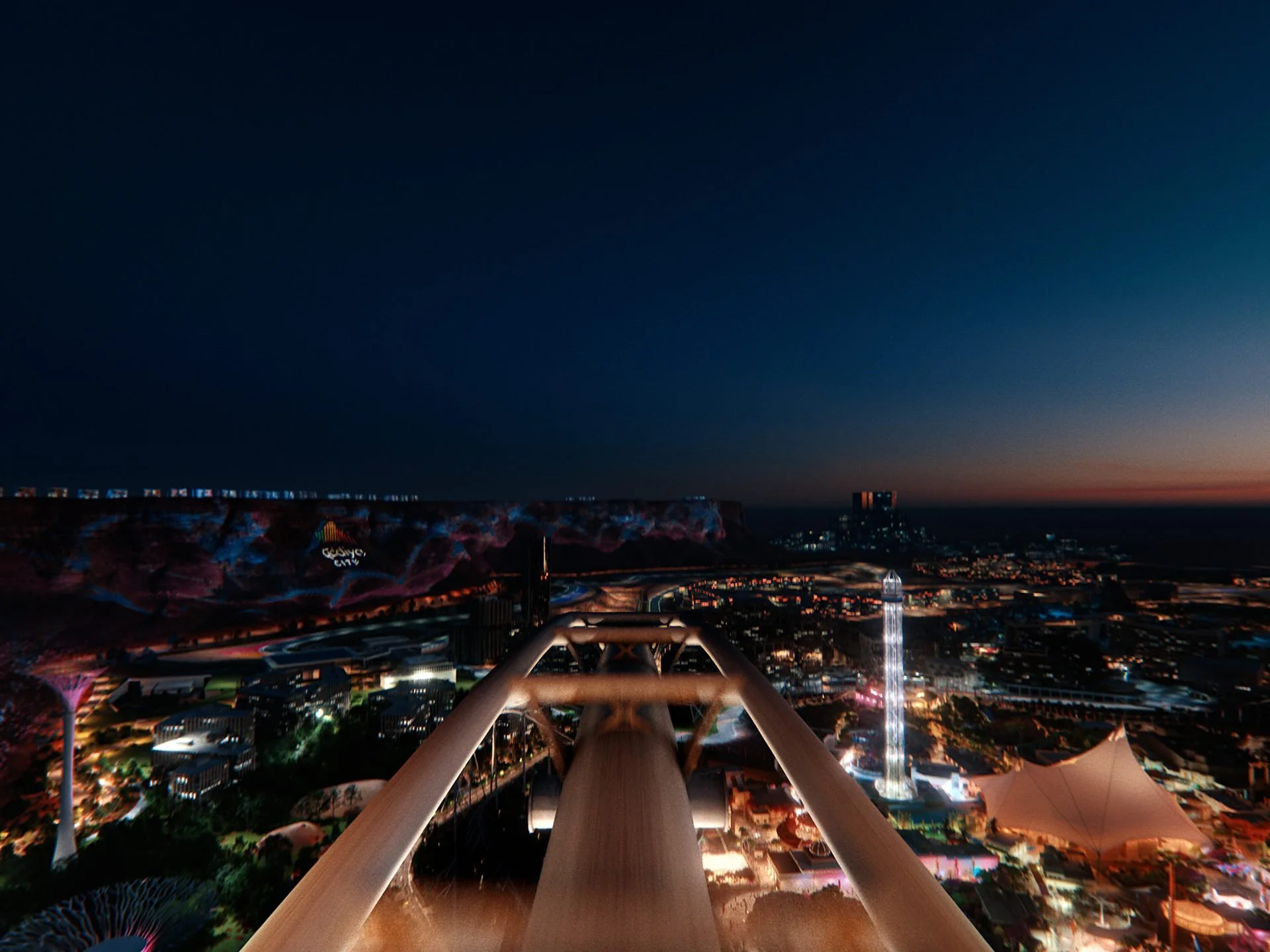 Night-time view from the top of a Qiddiya rollercoaster looking down over the
illuminated entertainment complex - the Red Sea coastline and city lights visible in the
distance