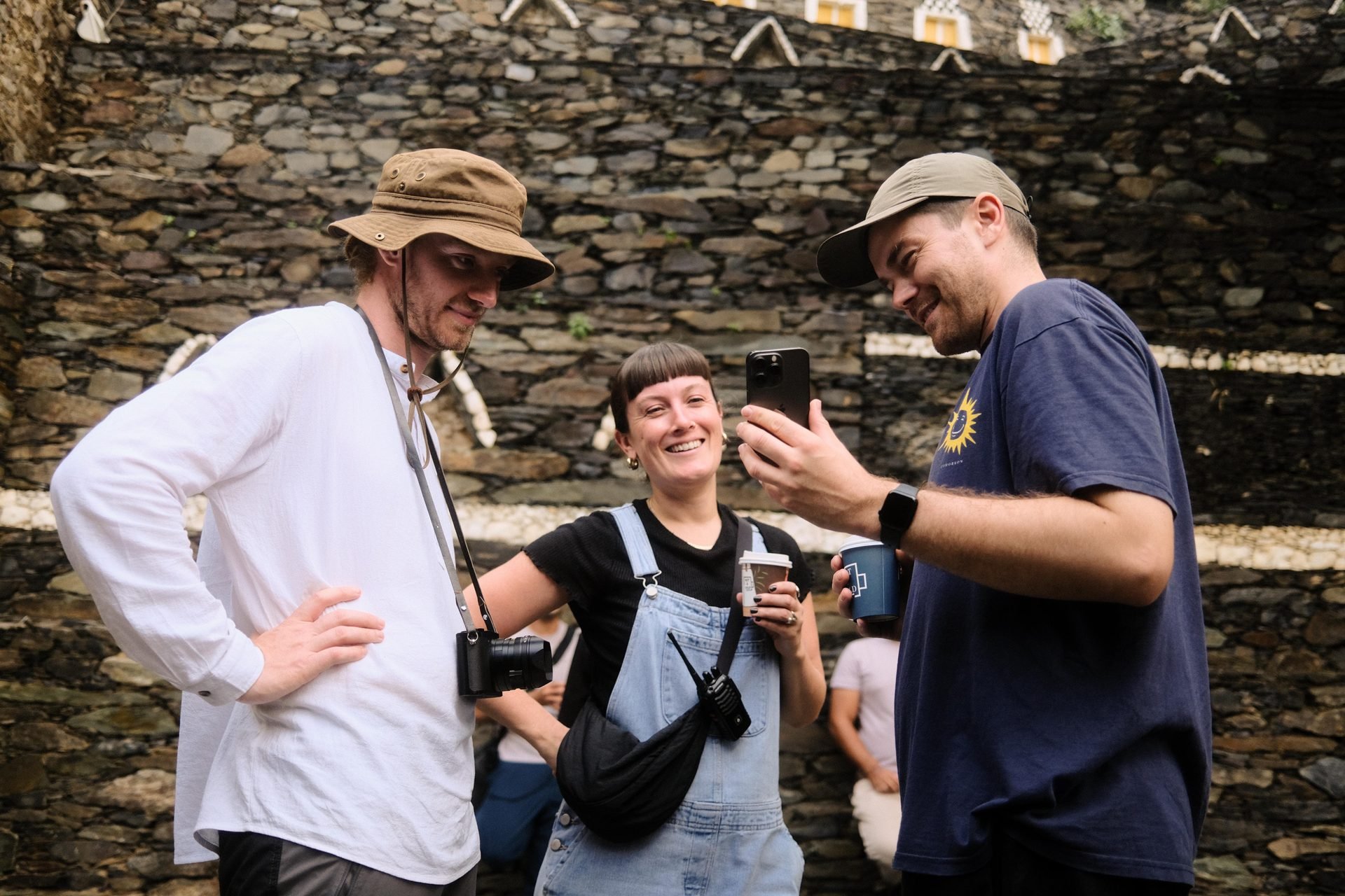 Crew members laughing and reviewing phone at Rijal Almaa during Evolving Cities shoot