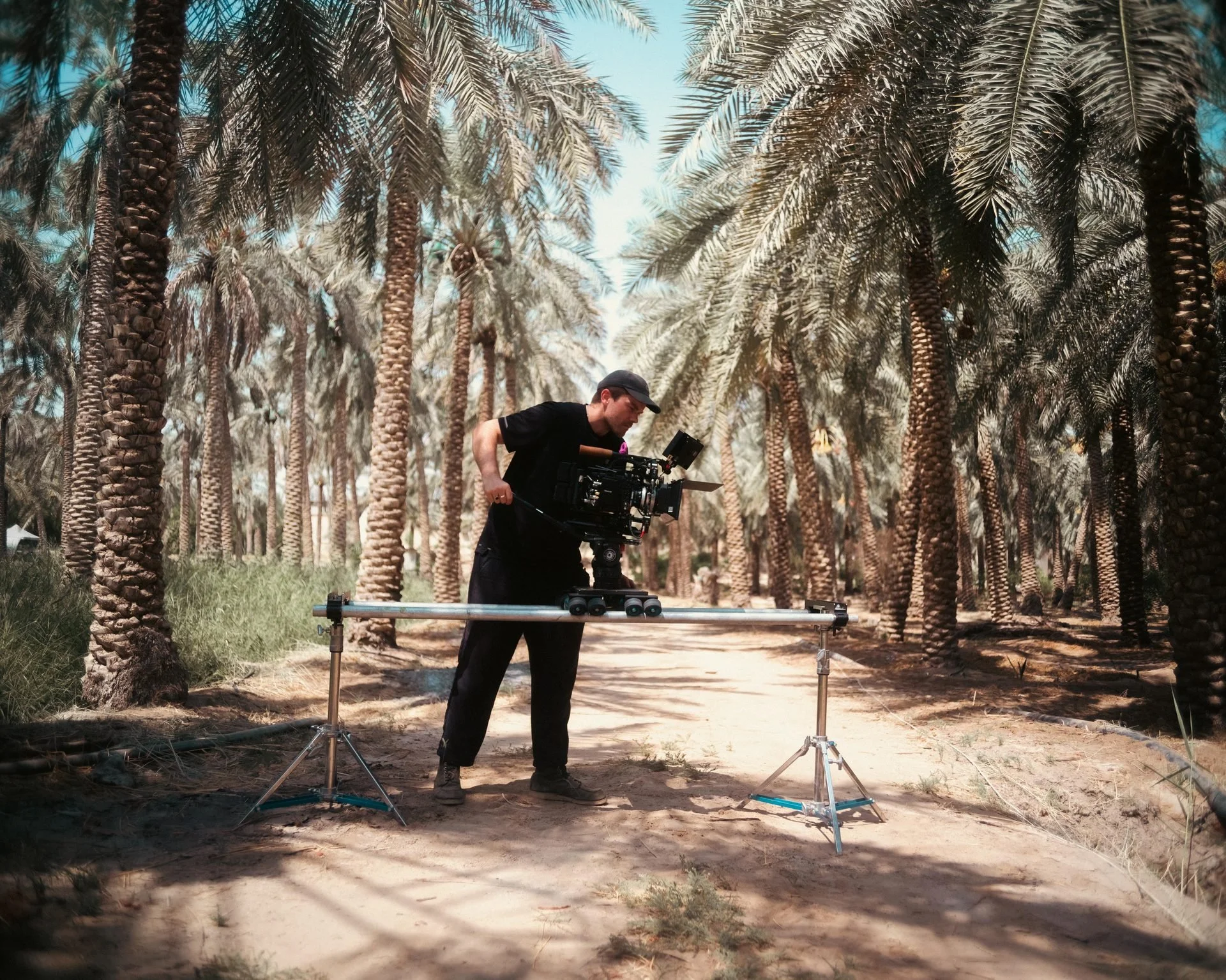 Crew at Al-Ahsa palm grove during sunset for Evolving Cities production