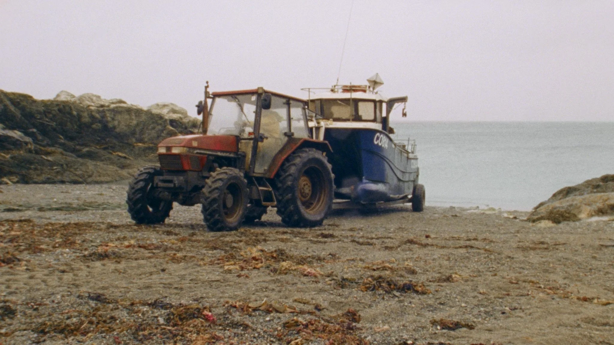 Tractor and fishing boat on a remote shoreline filmed for a food documentary.