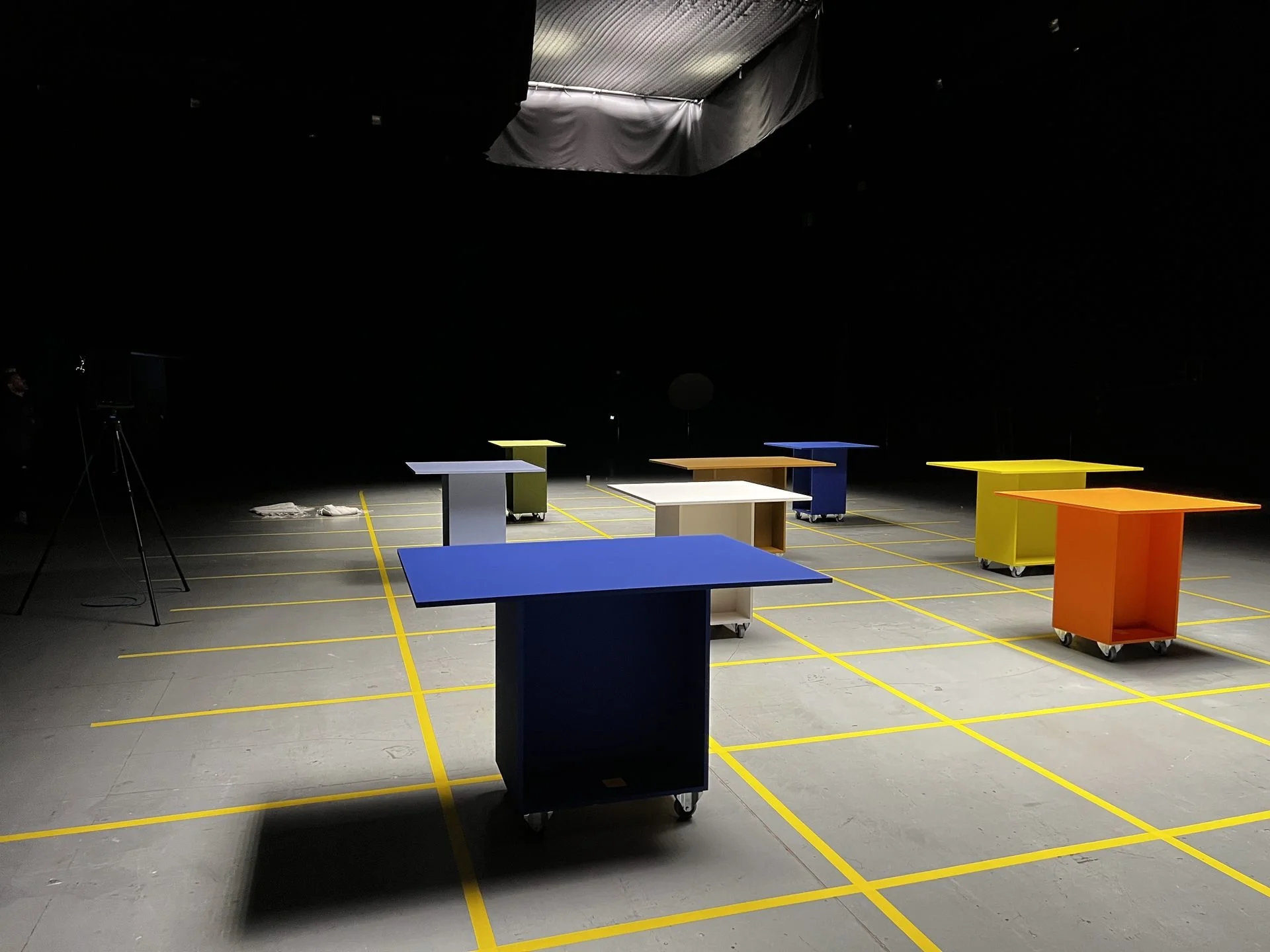 Colour-blocked plinths on yellow-gridded studio floor under suspended softbox, Marfa Stance
fashion film, DOP James Dougan