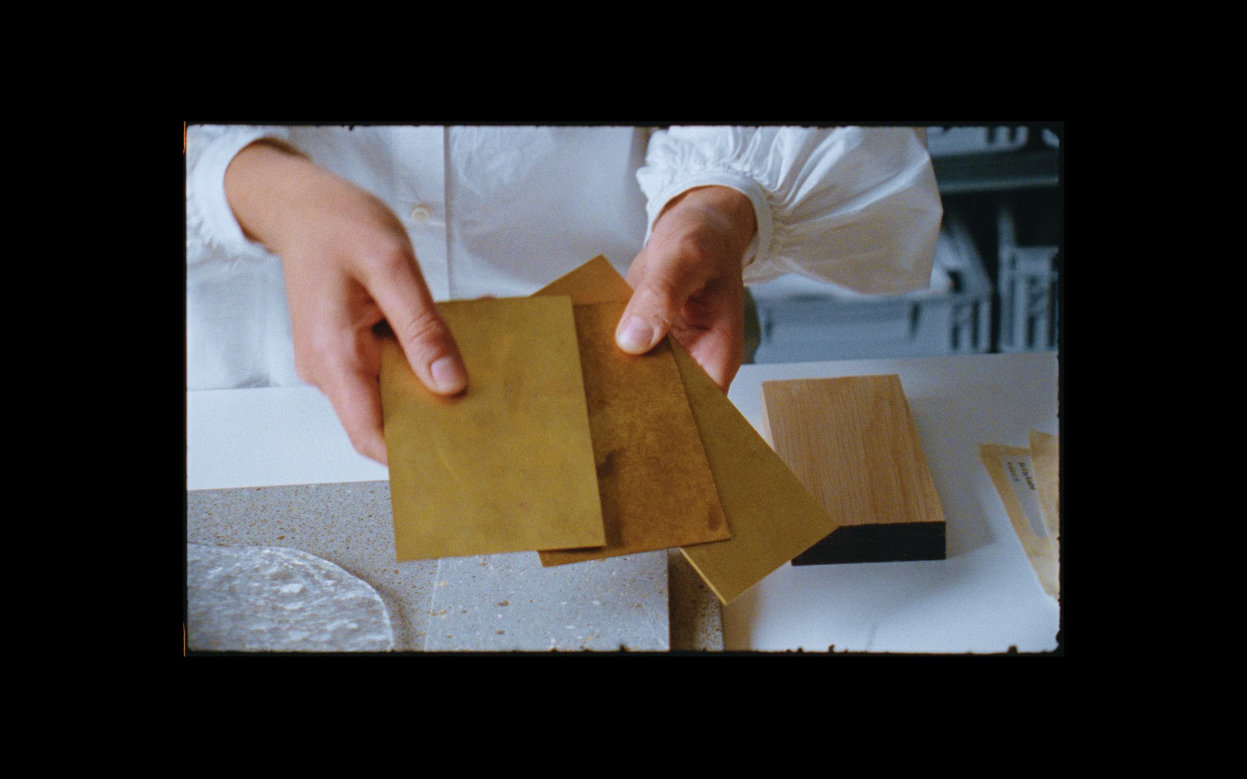 Close-up of architectural material selection filmed on 16mm, blending analogue texture with modern design-led documentary filmmaking.