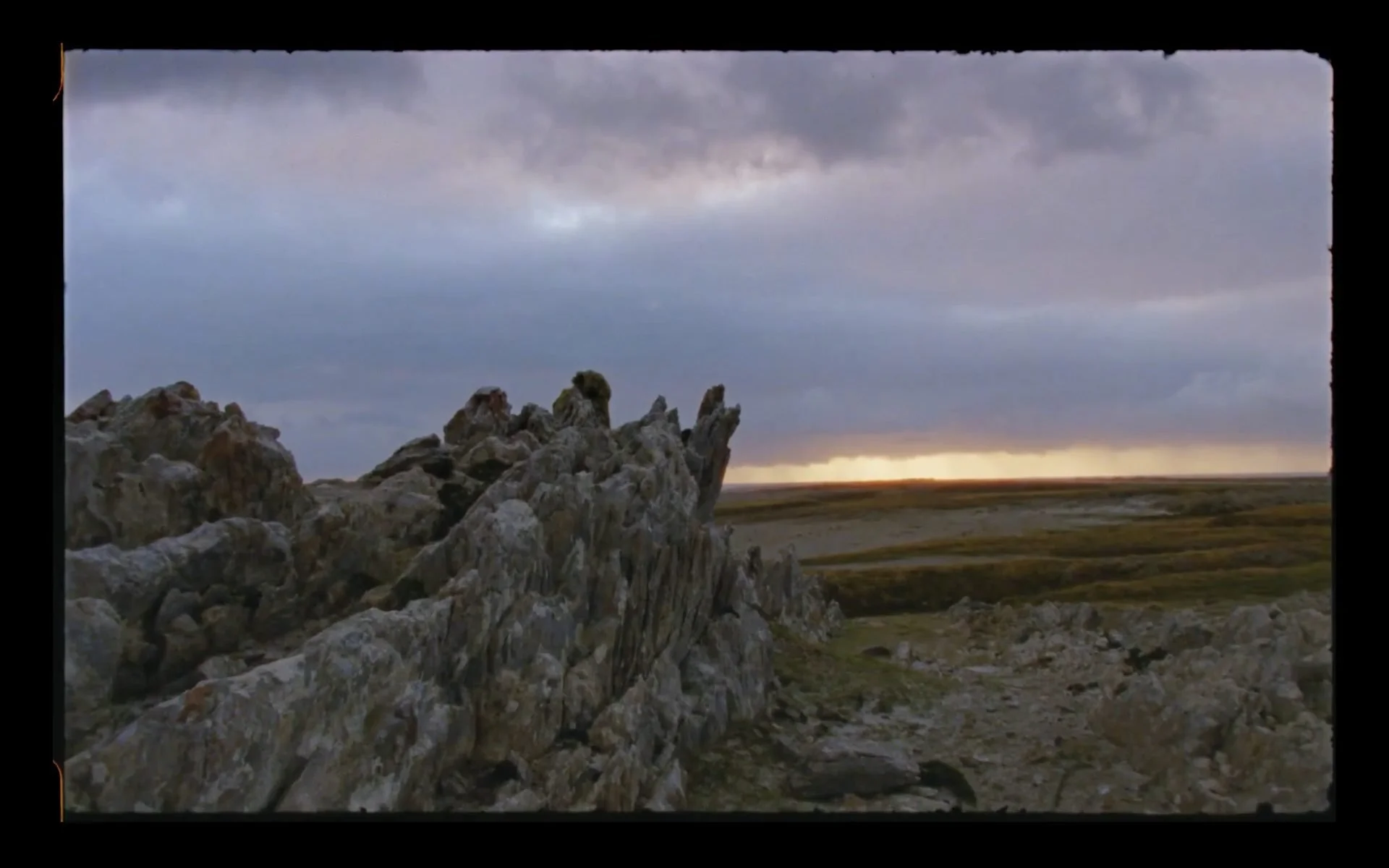 Dramatic stone runs and rocky outcrops against a golden sunset sky in
the Falkland Islands — 16mm film still from Connecting The Falklands