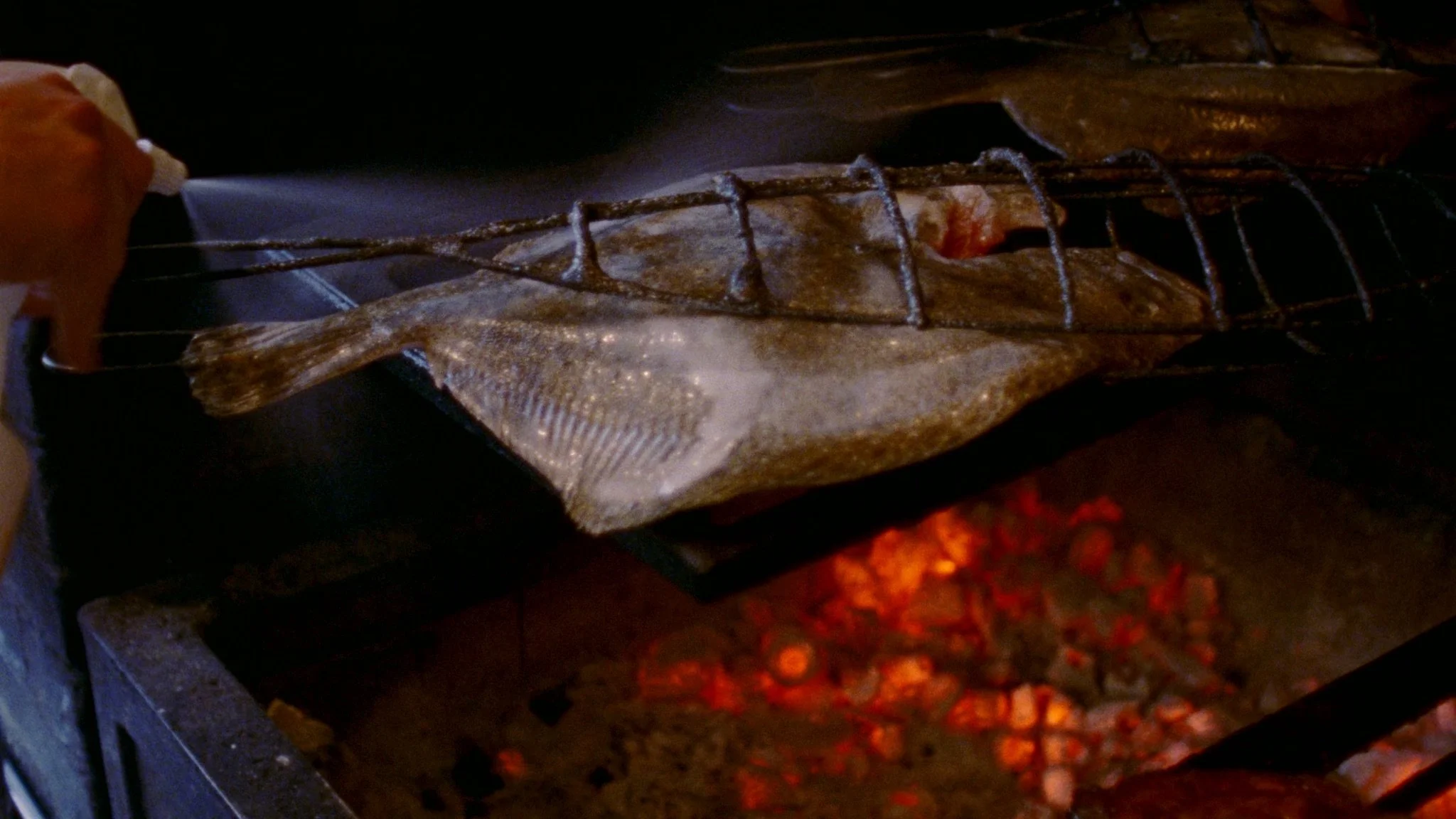 Turbot fish fish cooked on fire at Brat Restaurant in East London for branded documentary film