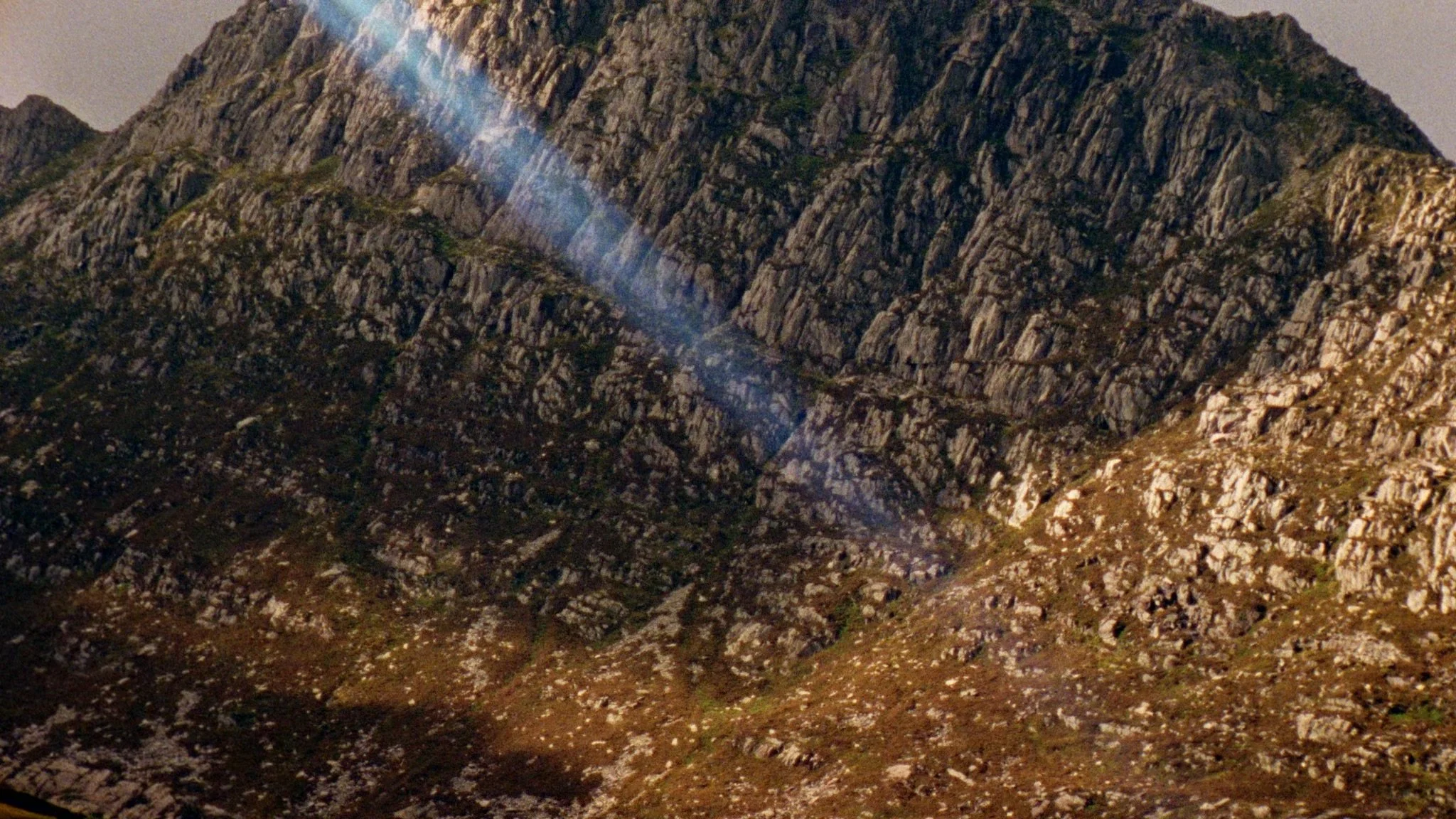 Close-up of a rocky mountain in the Wales Snowdonia captured on 16mm film, light leak