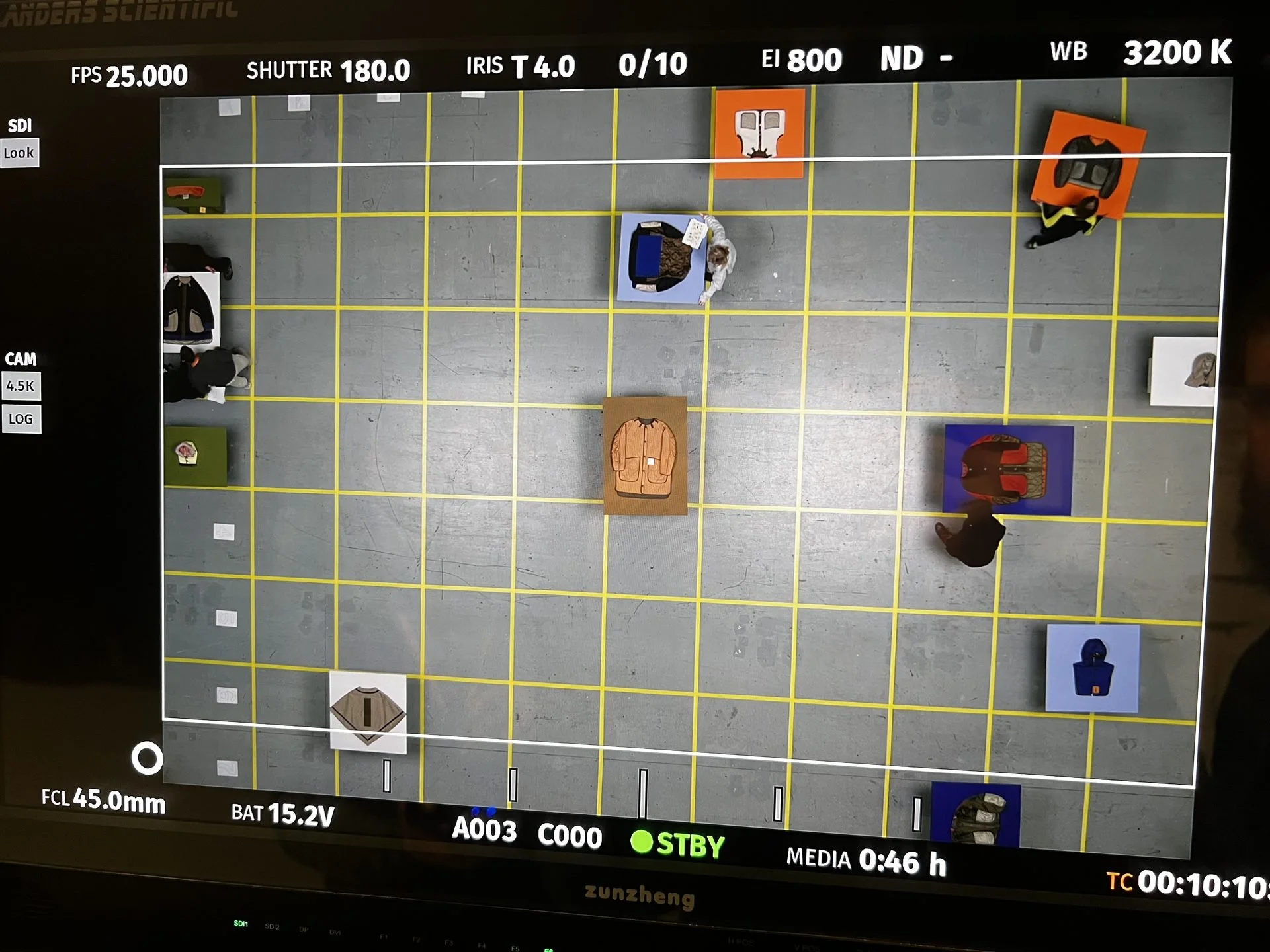 Flanders Scientific monitor showing overhead view of Marfa Stance garments on colour
plinths in grid, DOP James Dougan
