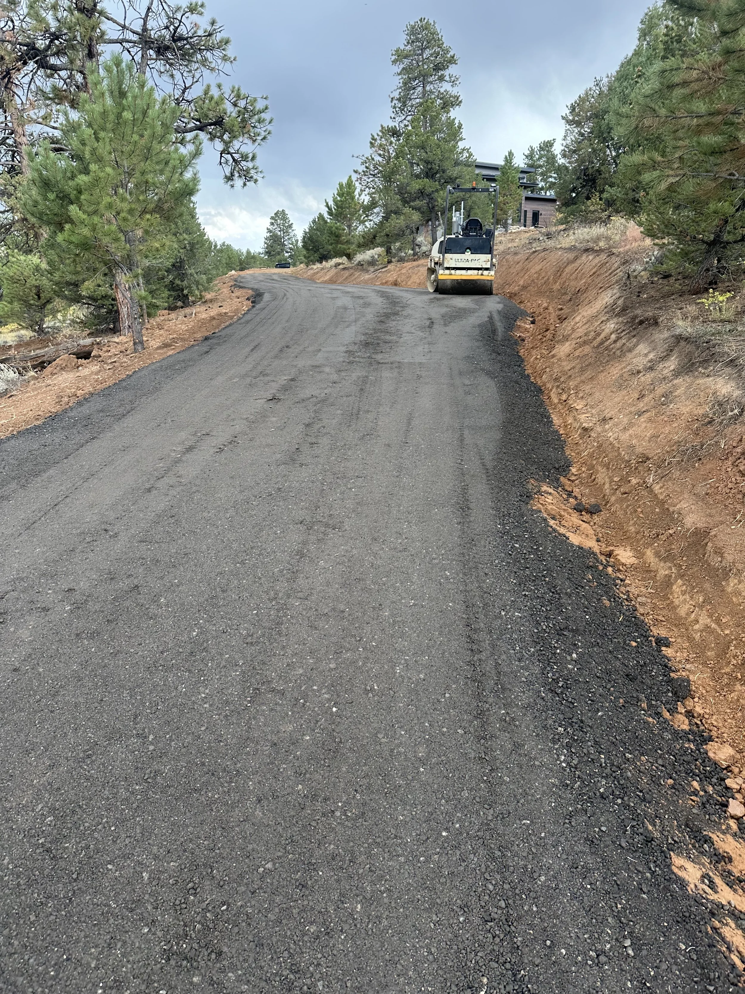 Compacting new road base on a mountain subdivision road in Chaffee County