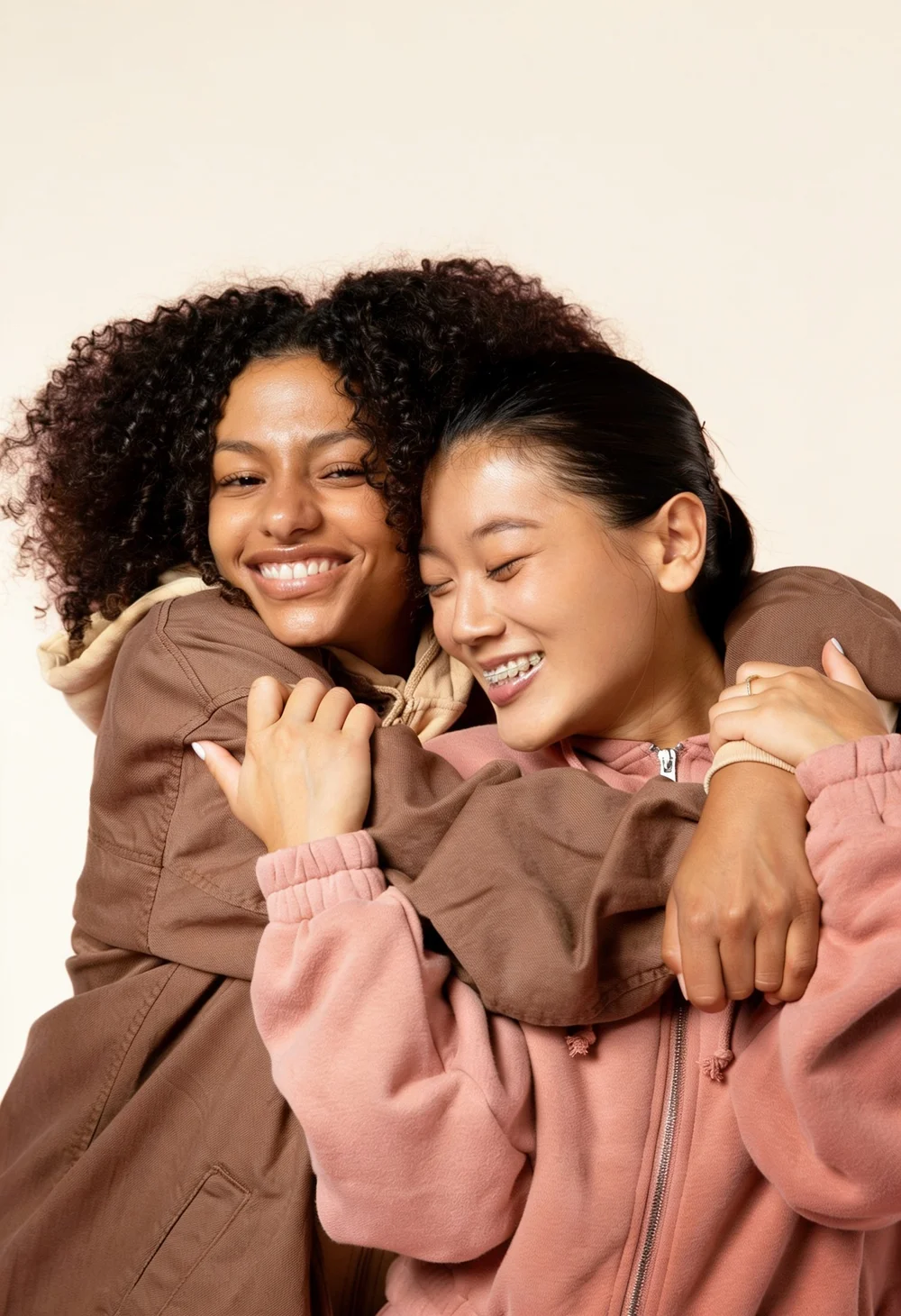 Two people smiling and leaning into an embrace.