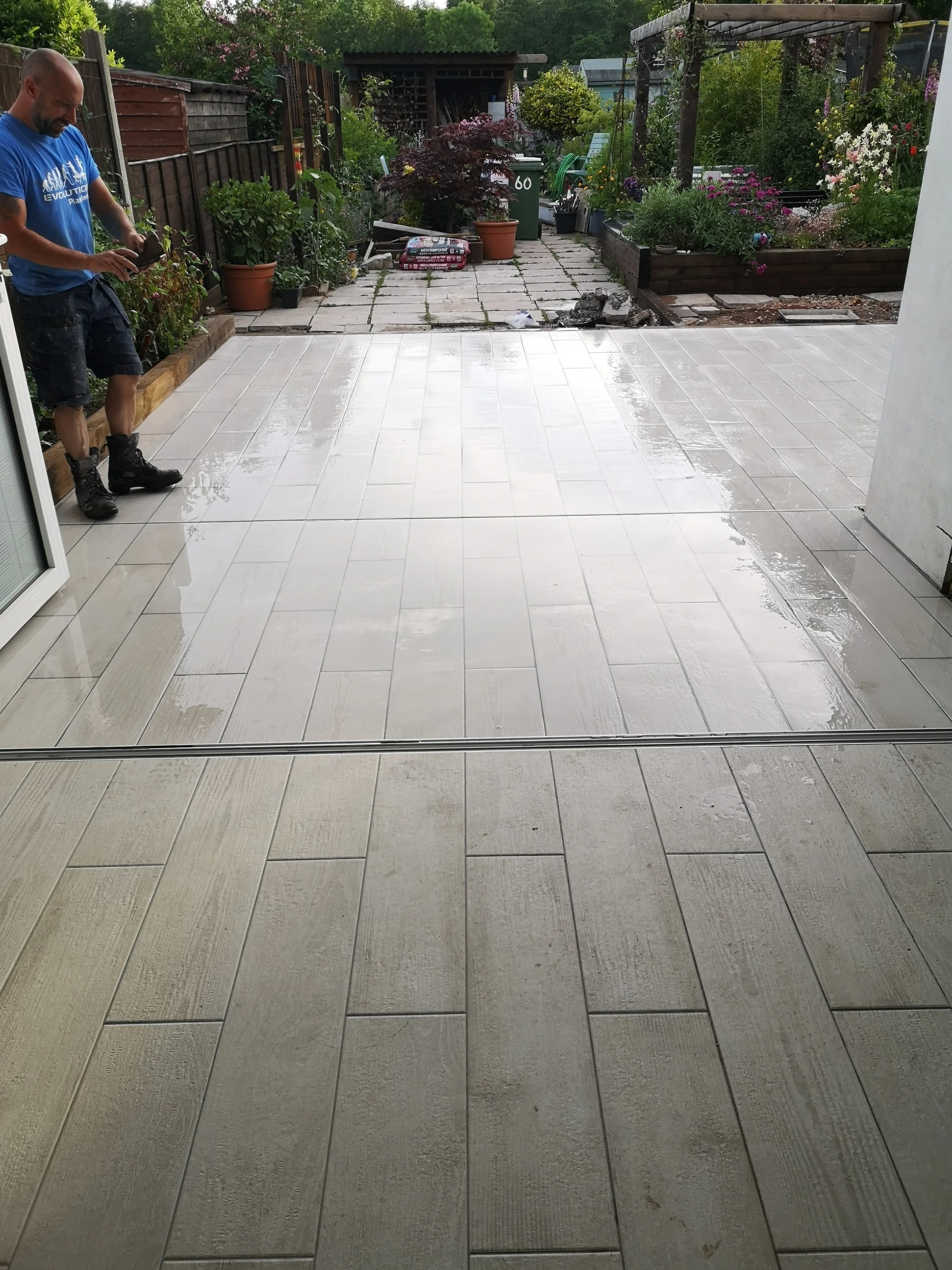 tiles with a hidden bifold threshold to create a seamless finish to create nice flow from inside to out