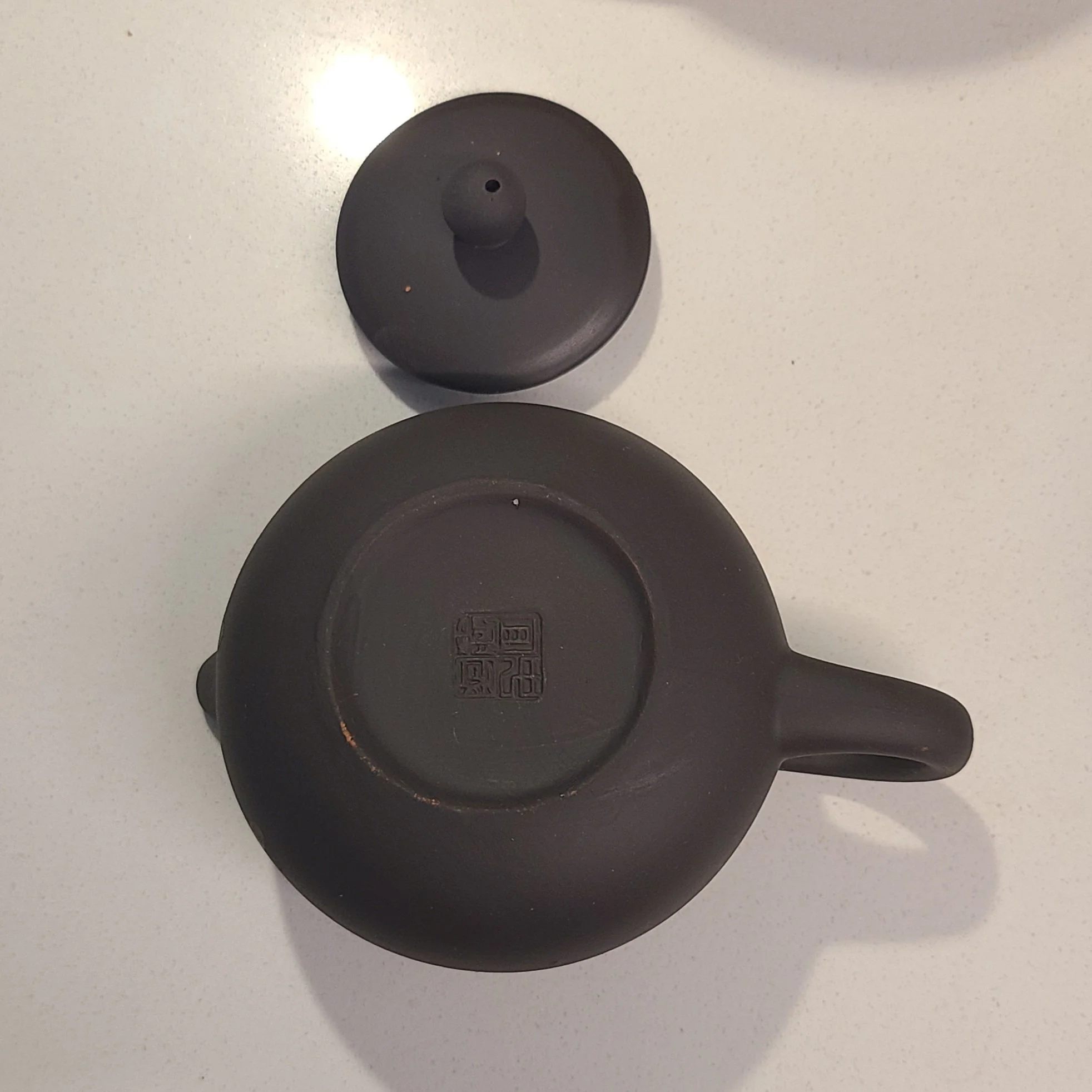 stamped, hole in lid not centred, lid does not fit well