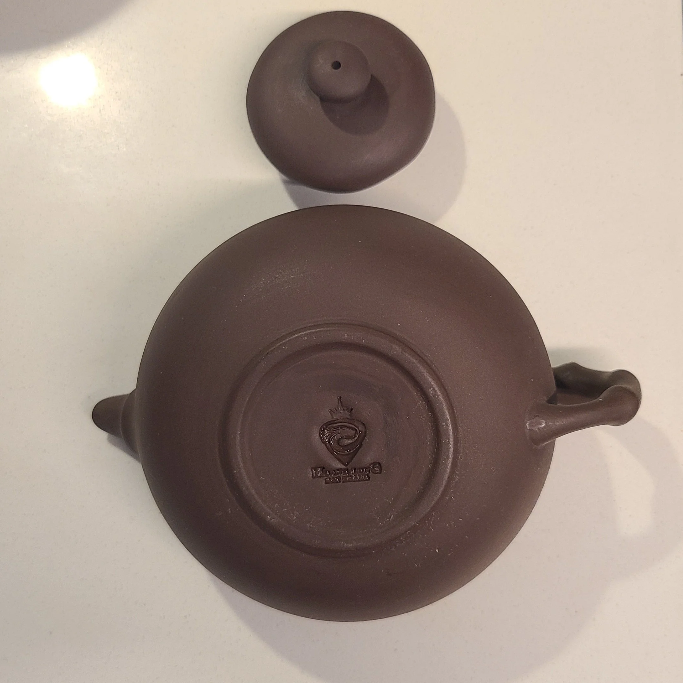 stamped - does not lie flat when turned over, the lid fits well