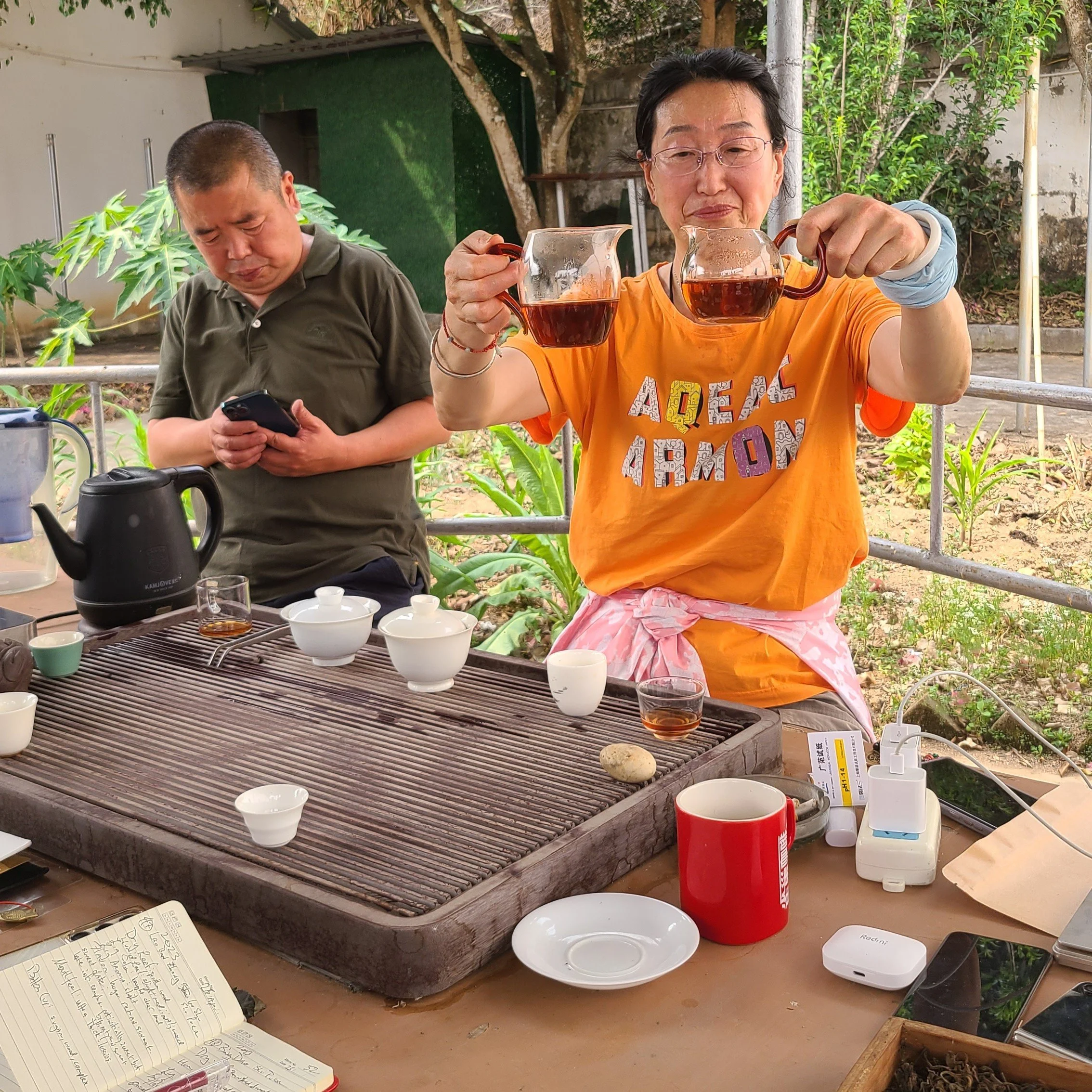Wei Feng &amp; Jianli serving tea at the farm