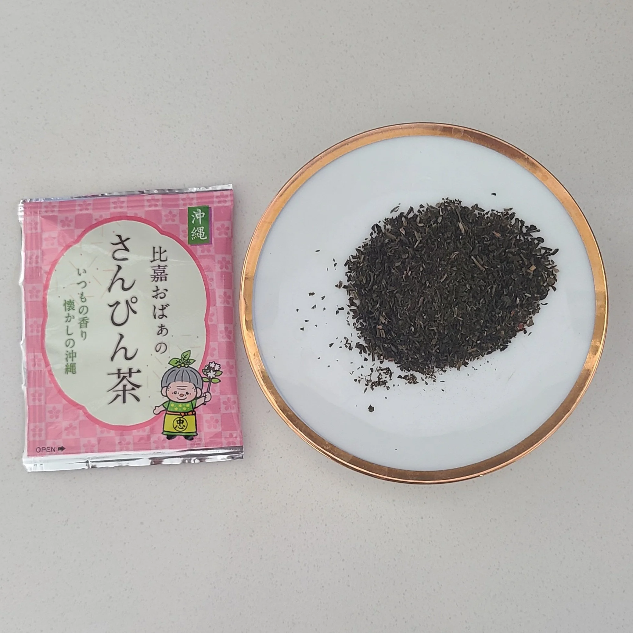 opened tea bag with fine dark brown cut leaves