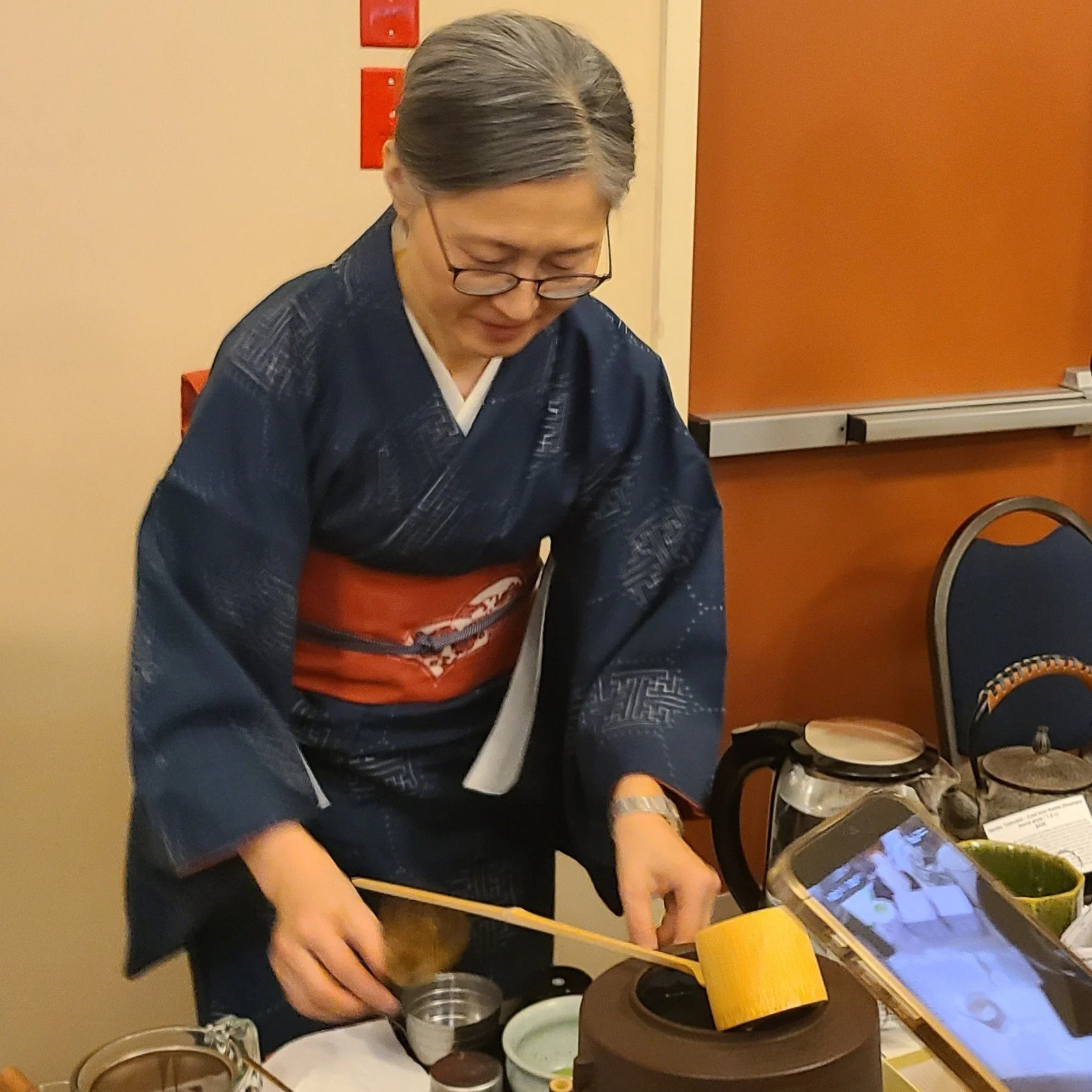 Elegant woman from Matsu Kaze preparing matcha