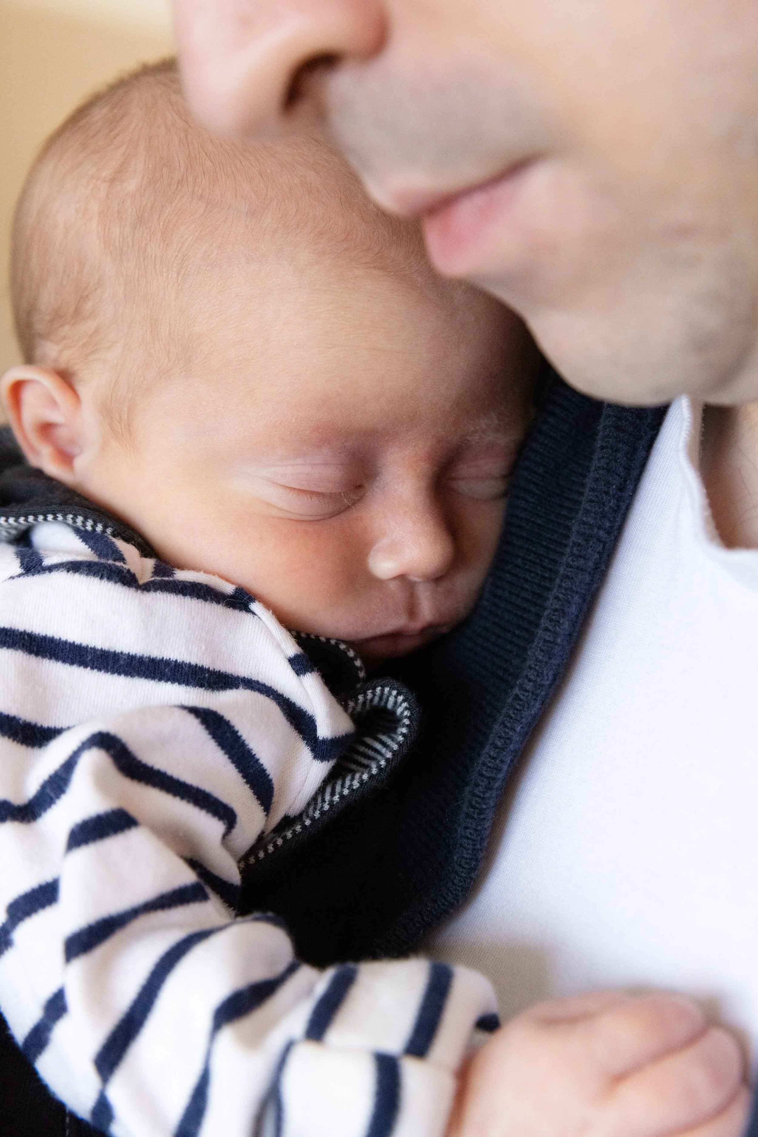 Close photo of newborn baby being held by their dad during their newborn photoshoot in North Tyneside