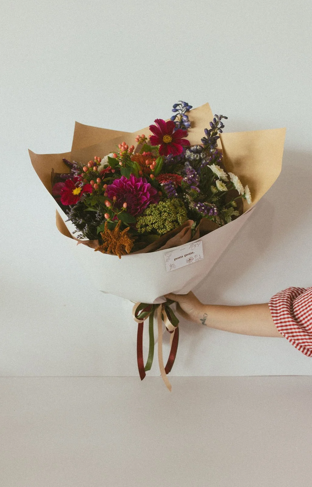 girl holding bouquet of flowers wrapped (Copy)