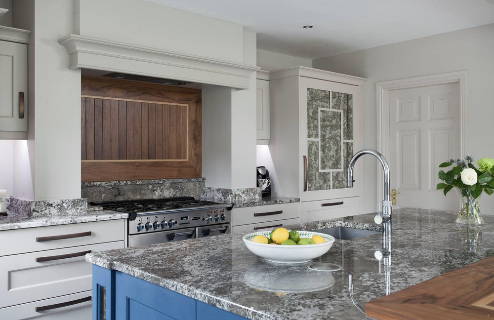 Mantle feature with a Walnut backsplash and Oak Inlay, Rangemaster range and solid Quartz worktops including upstands and sill feature