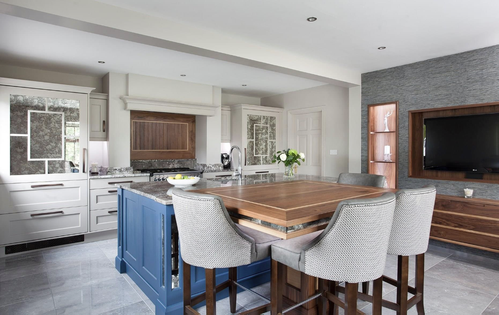 Kitchen and dining area with home entertainment unit including the television and open shelving