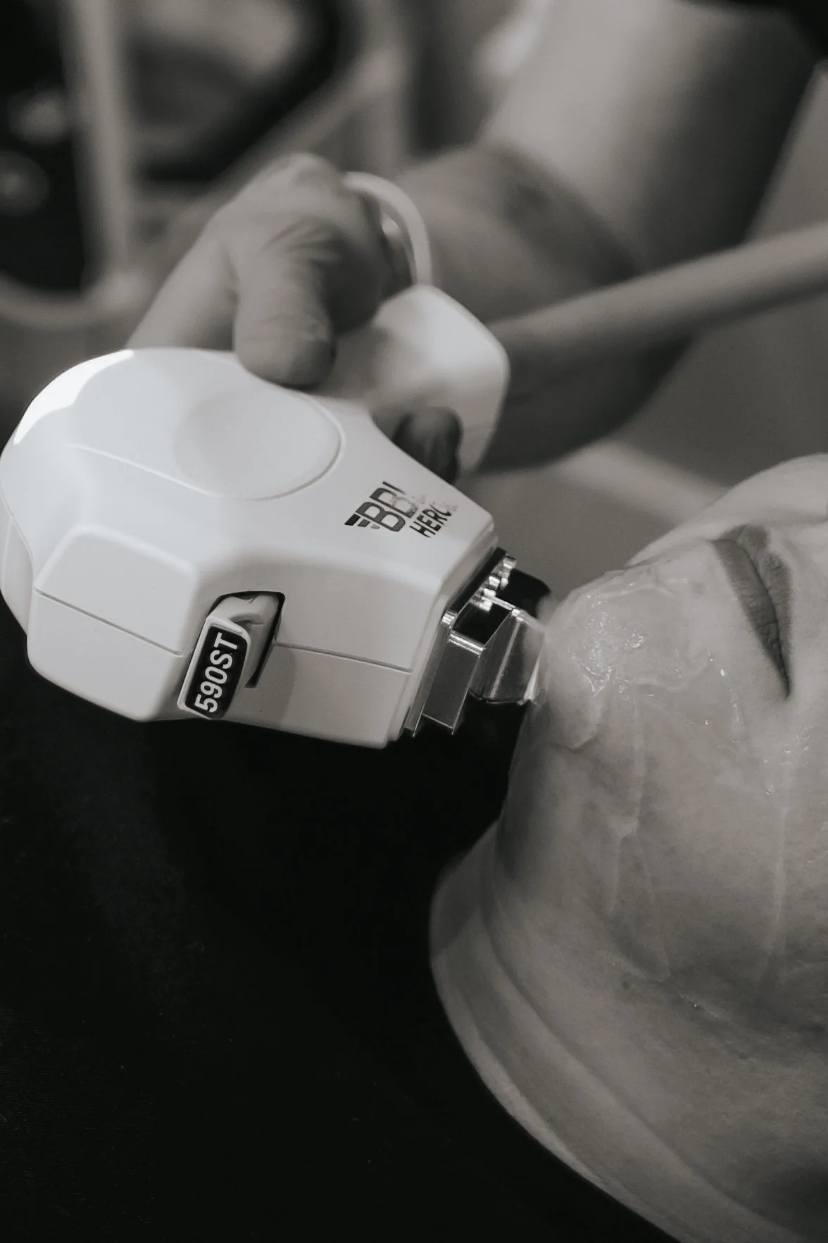 A healthcare professional wearing gloves is administering a vaccination with a syringe into a patient's arm.