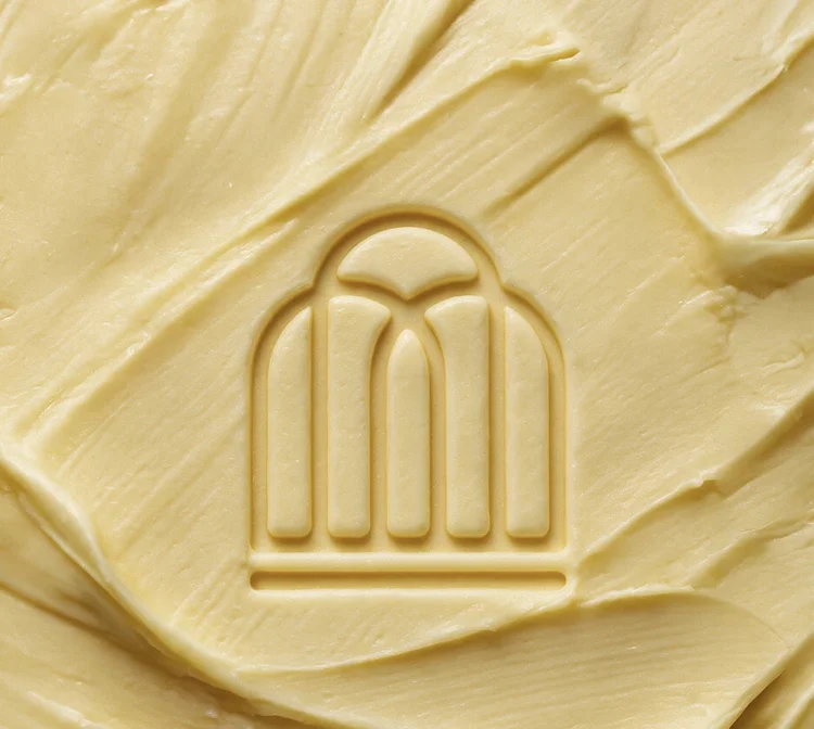 Arch logo mark pressed into butter, logo design mockup by CL42ITY