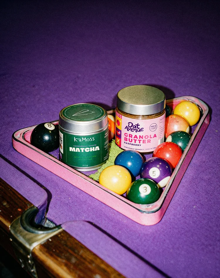 KaMoss matcha tins in a pool ball rack, campaign photography by CL42ITY
